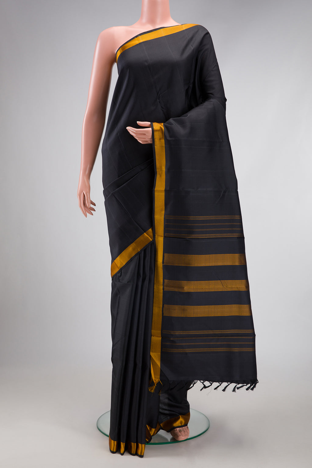 Black Kanjivaram Silk Saree with Plain Body and Thread Border.  displayed on a mannequin