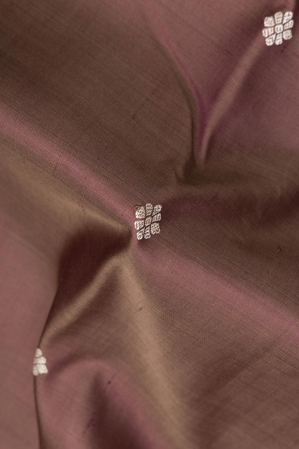 Close up of Pure Silk Brown Kanjivaram Saree with Thread Butta on the body and Thread Border.  displaying folds
