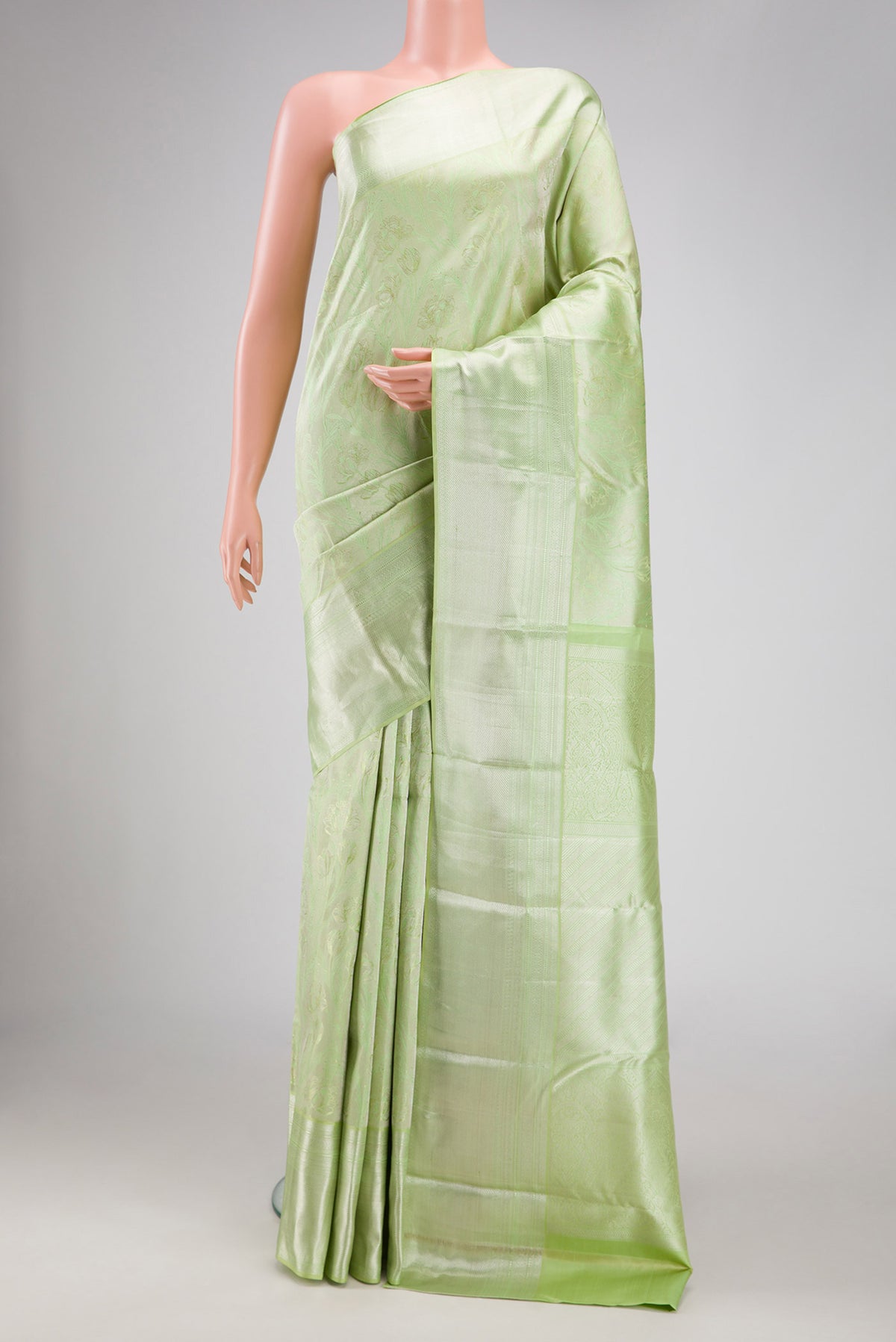 Pista Green Dual Tone Kanjivaram Silk Saree with Zari Brocade on the body and Zari Border.  displayed on a mannequin
