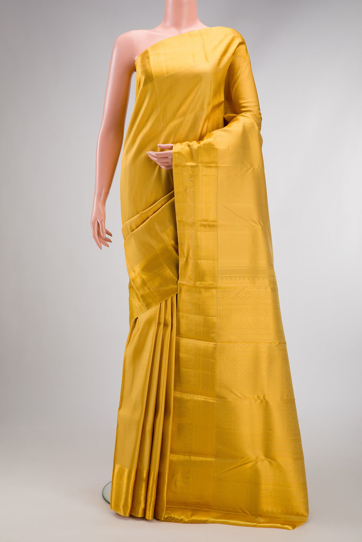 Yellow Kanjivaram Silk Saree with Zari Brocade on the body and Zari Border.  displayed on a mannequin