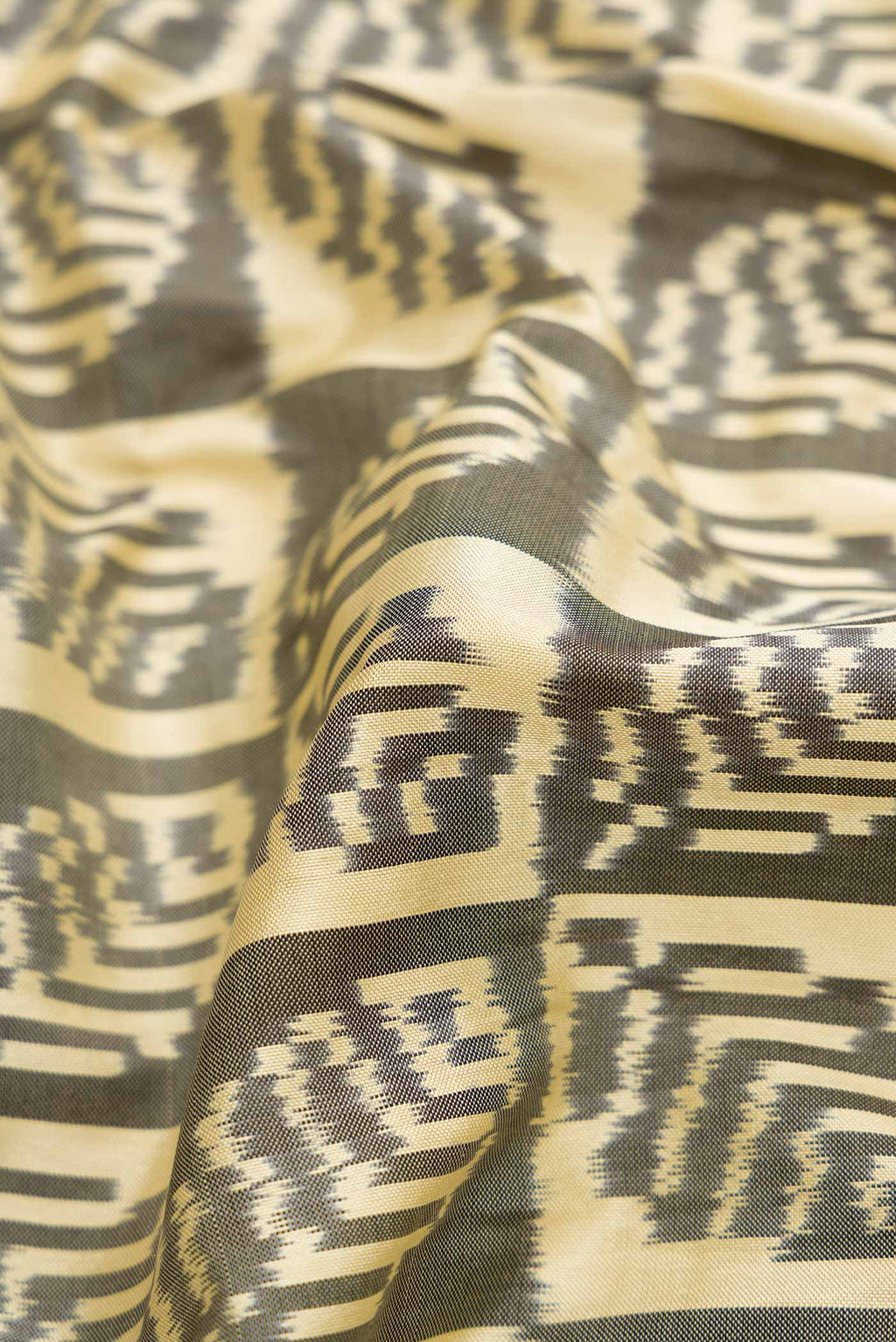 Close up of Sandal Pochampally Silk Saree with Pure Ikat on the body and Zari Border displaying folds