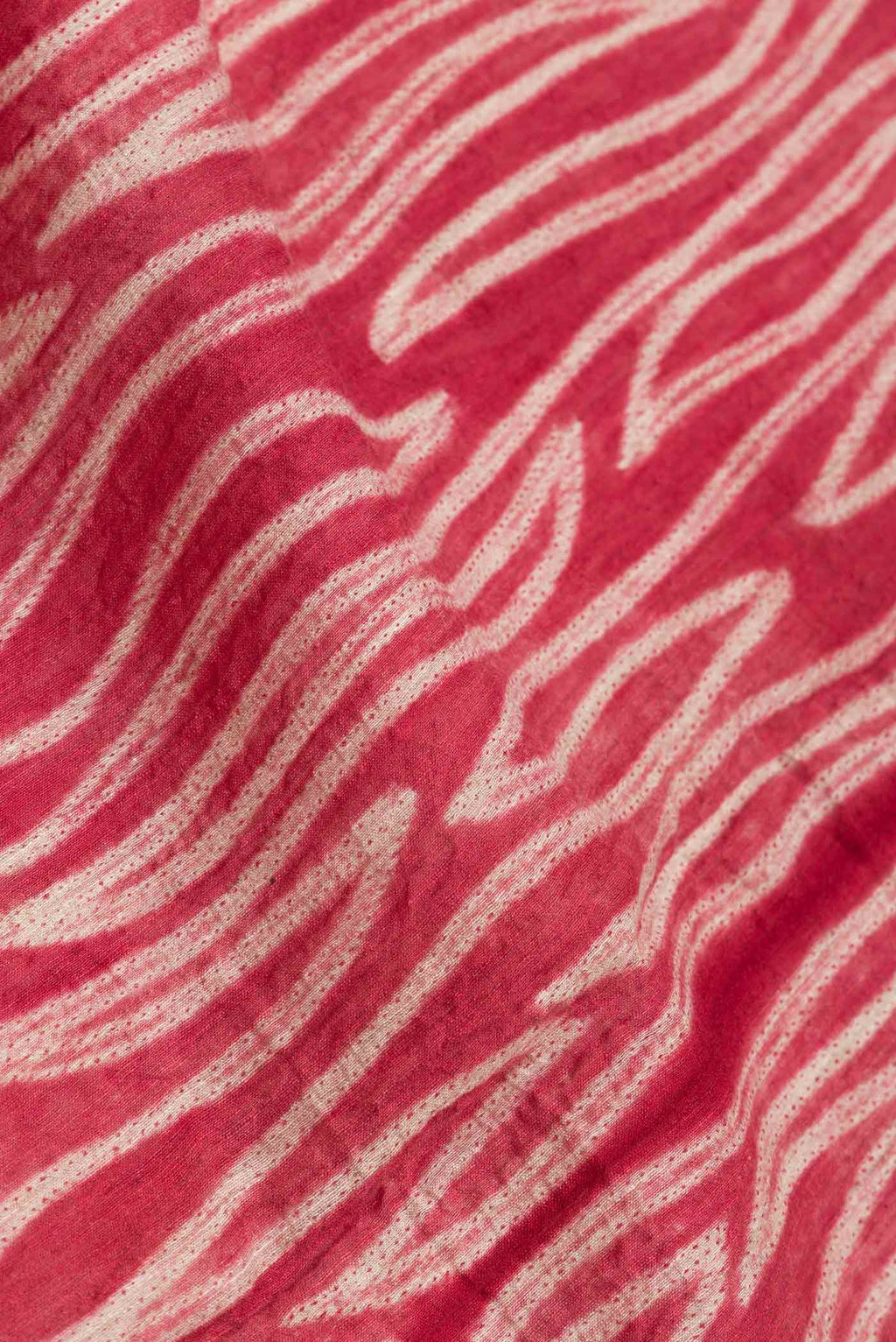 Close up of Maroon Dual Tone Tussar Saree with Printed design on the body and Plain Border.  displaying folds