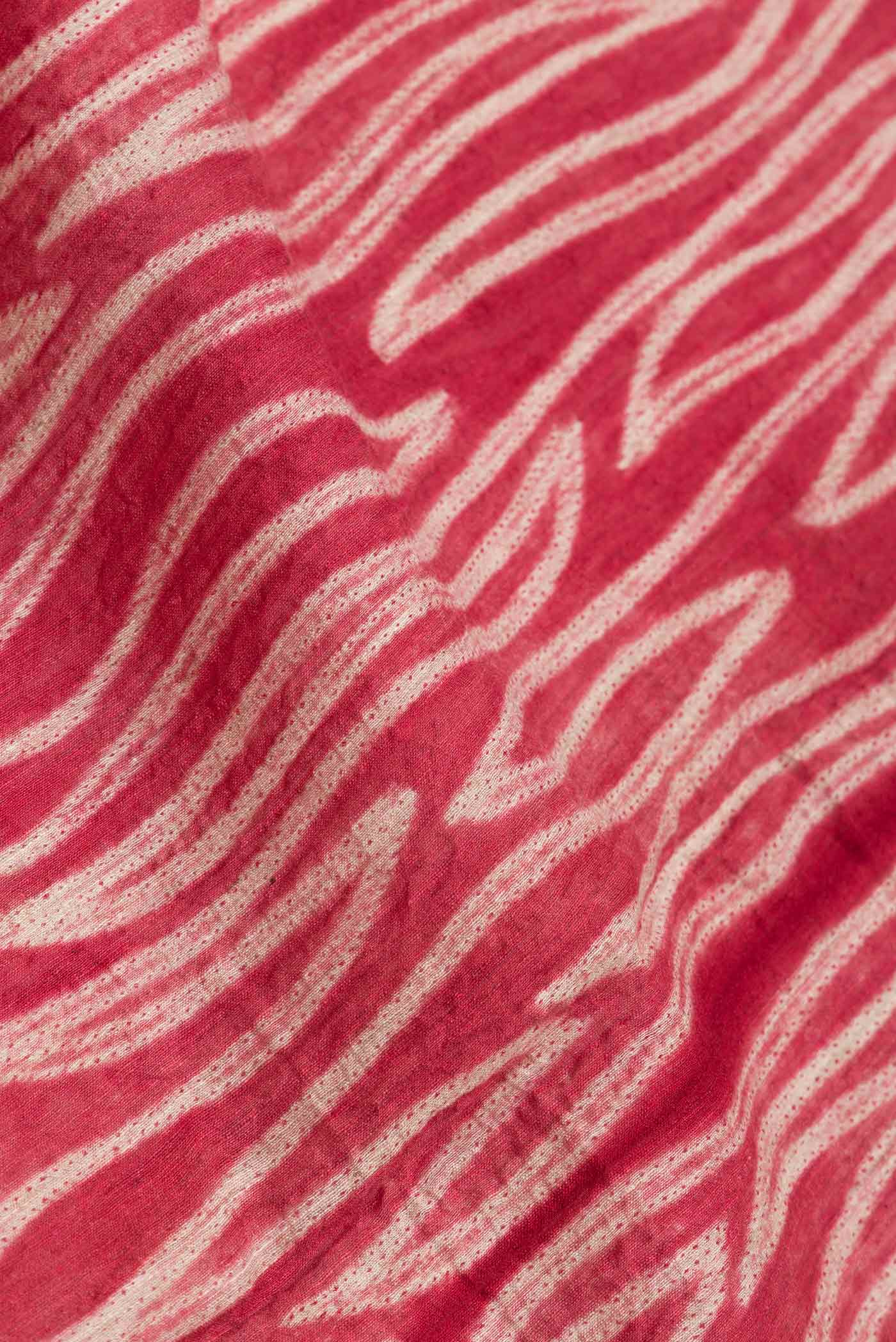 Close up of Maroon Dual Tone Tussar Saree with Printed design on the body and Plain Border.  displaying folds