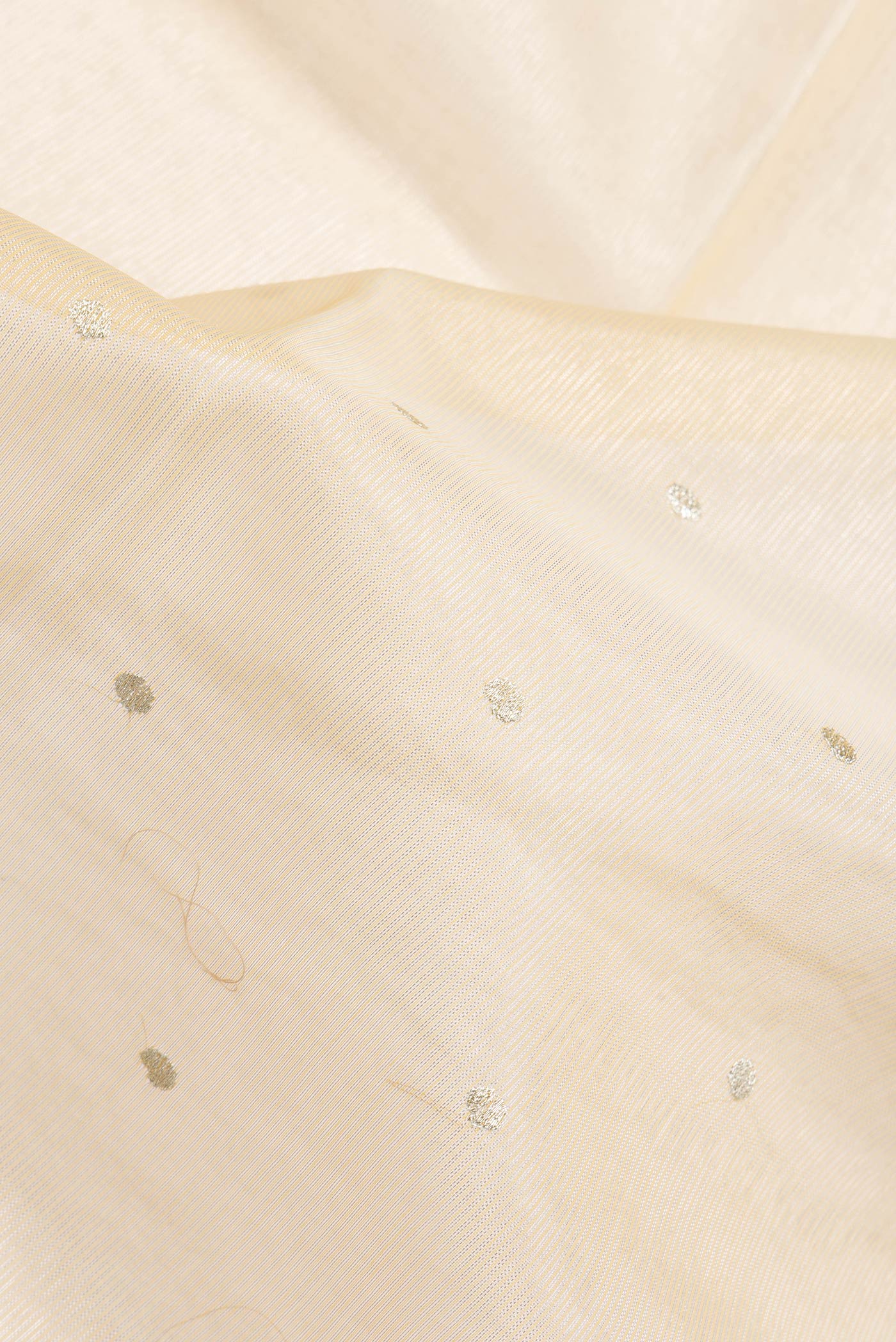 Close up of Sandal Dual Tone Organza Silk Saree with Zari Butta on the body and Fancy Border.  displaying folds