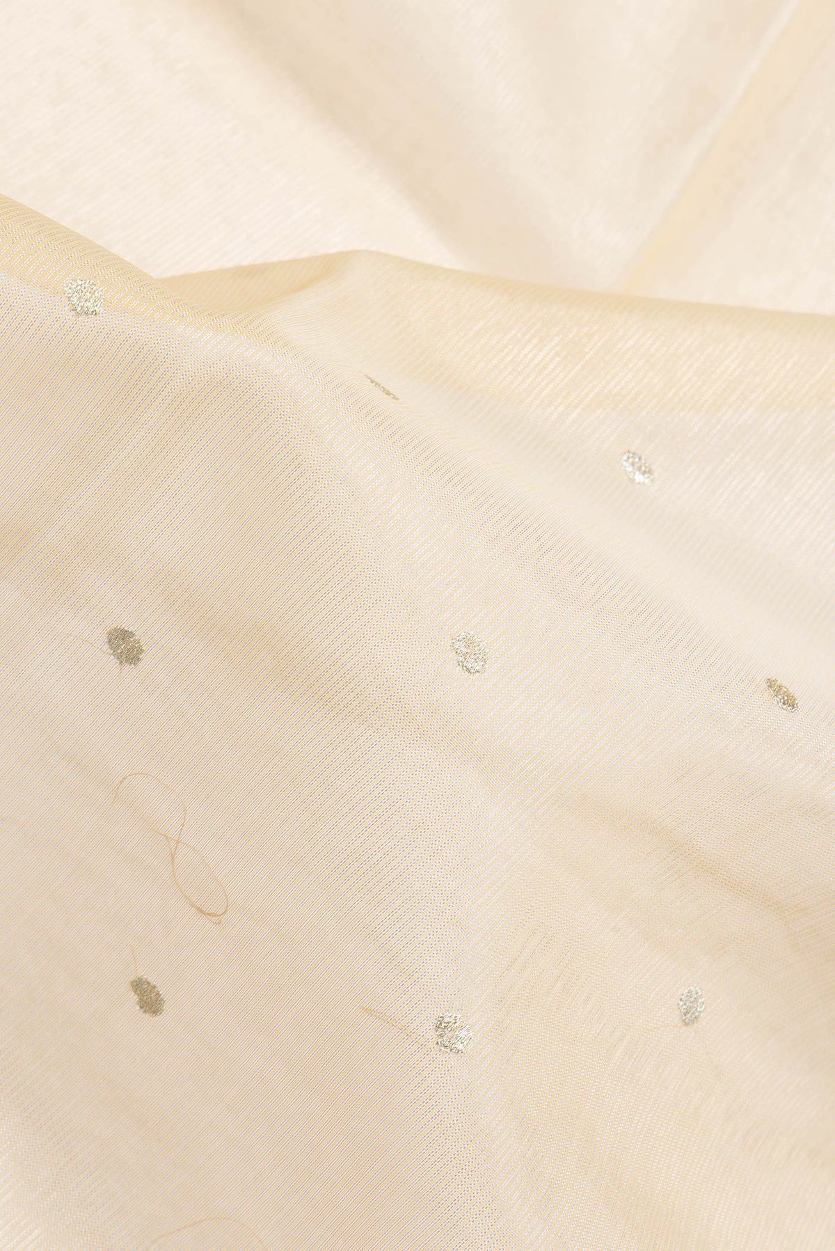Close up of Sandal Dual Tone Organza Silk Saree with Zari Butta on the body and Fancy Border.  displaying folds
