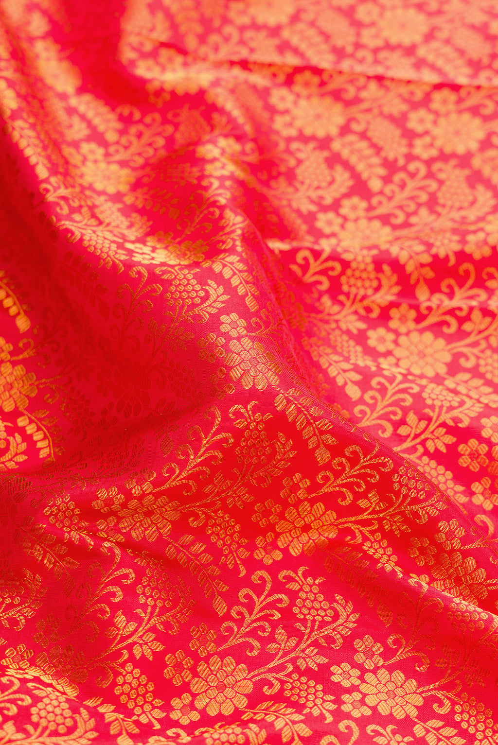 Close up of Red Dual Tone Kanjivaram Silk Saree with Zari Brocade on the body and Zari Border.  displaying folds