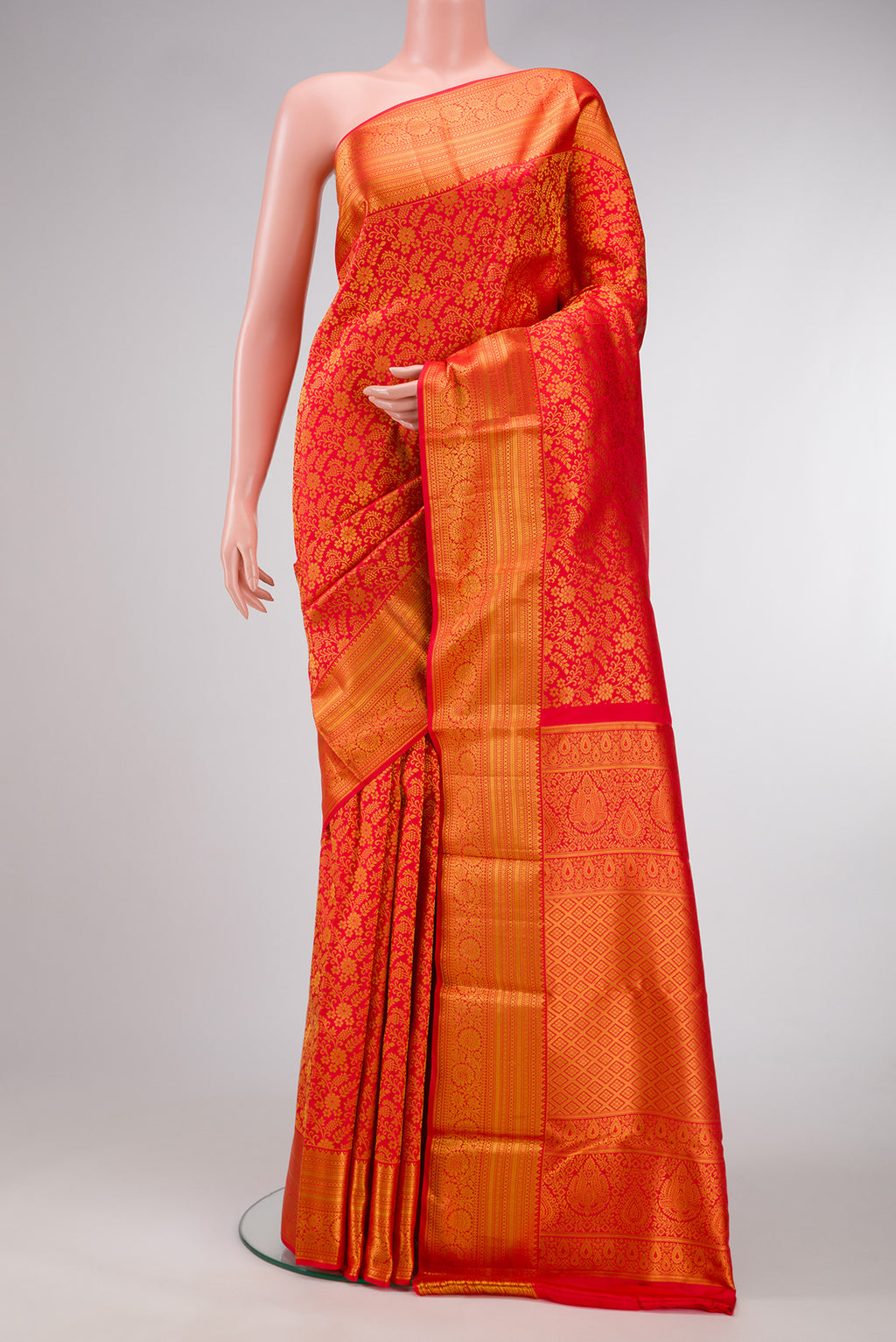 Red Dual Tone Kanjivaram Silk Saree with Zari Brocade on the body and Zari Border.  displayed on a mannequin