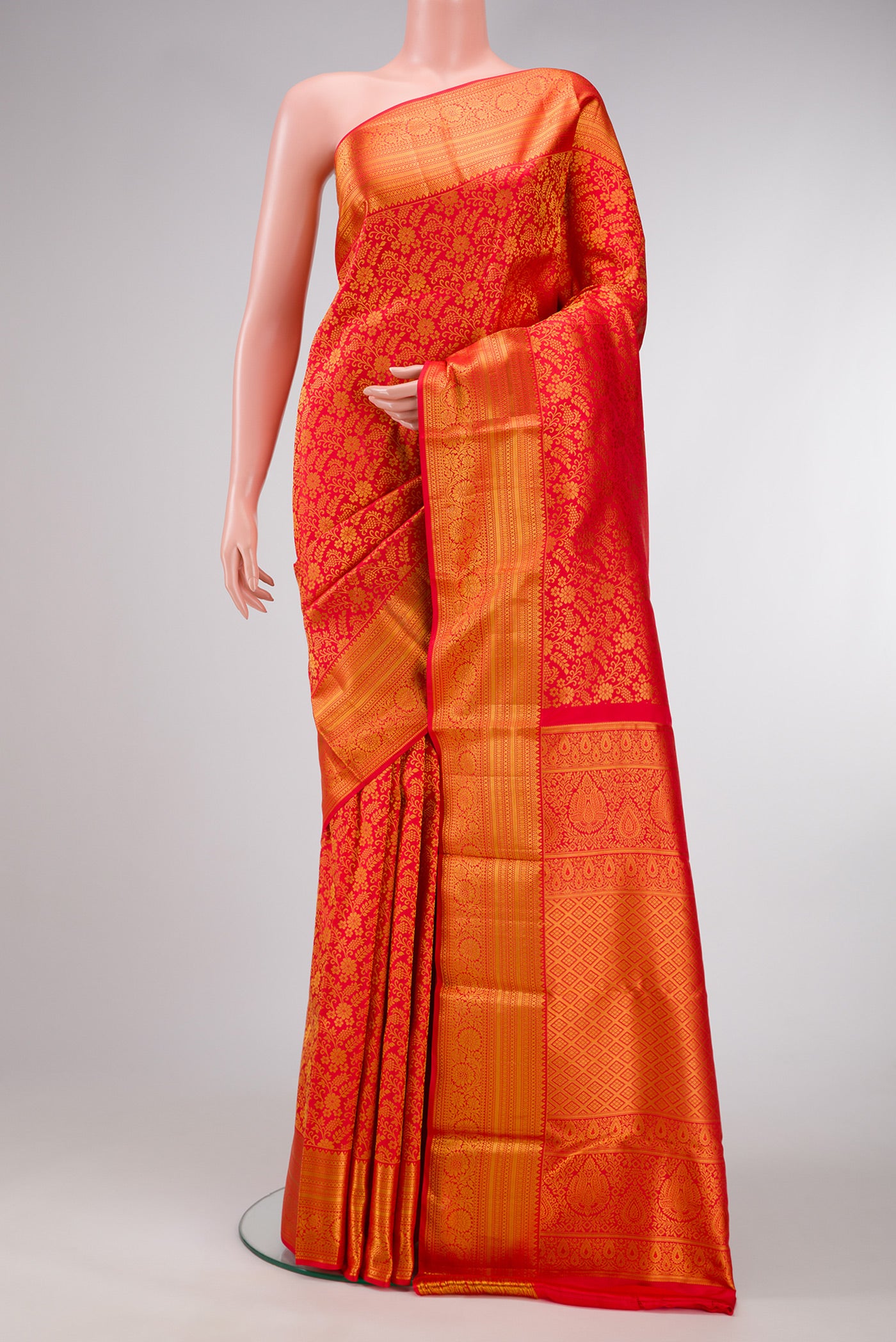 Red Dual Tone Kanjivaram Silk Saree with Zari Brocade on the body and Zari Border.  displayed on a mannequin