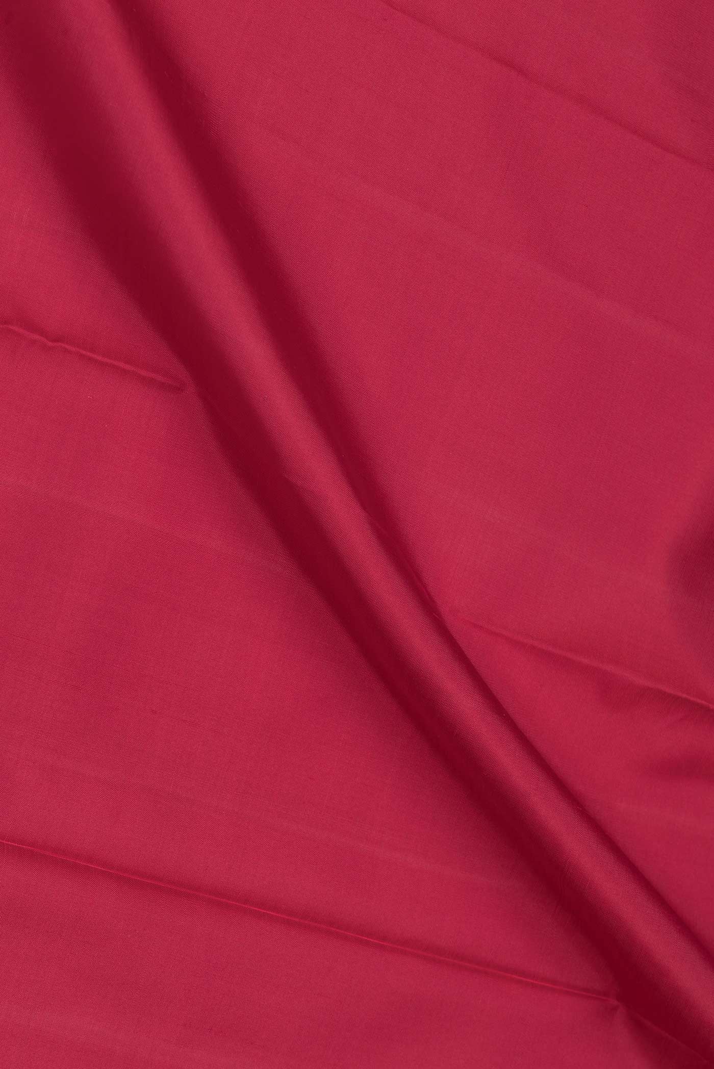 Close up of Maroon Dual Tone Kanchipuram Saree with Plain Body and Temple Border.  displaying folds