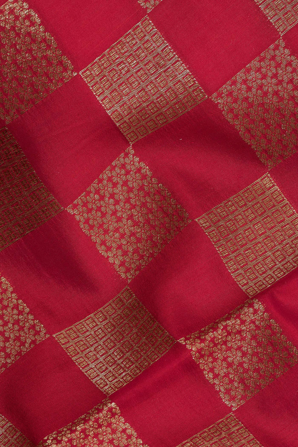 Close up of Pure Silk Red Tussar Saree with Zari Brocade on the body and Zari Border.  displaying folds