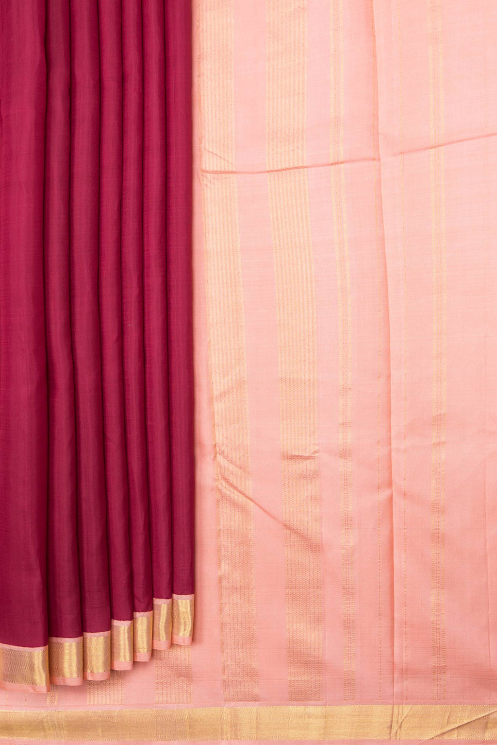 Pleats and pallu of Maroon Dual Tone Kanchipuram Saree with Plain Body and Zari Border. 