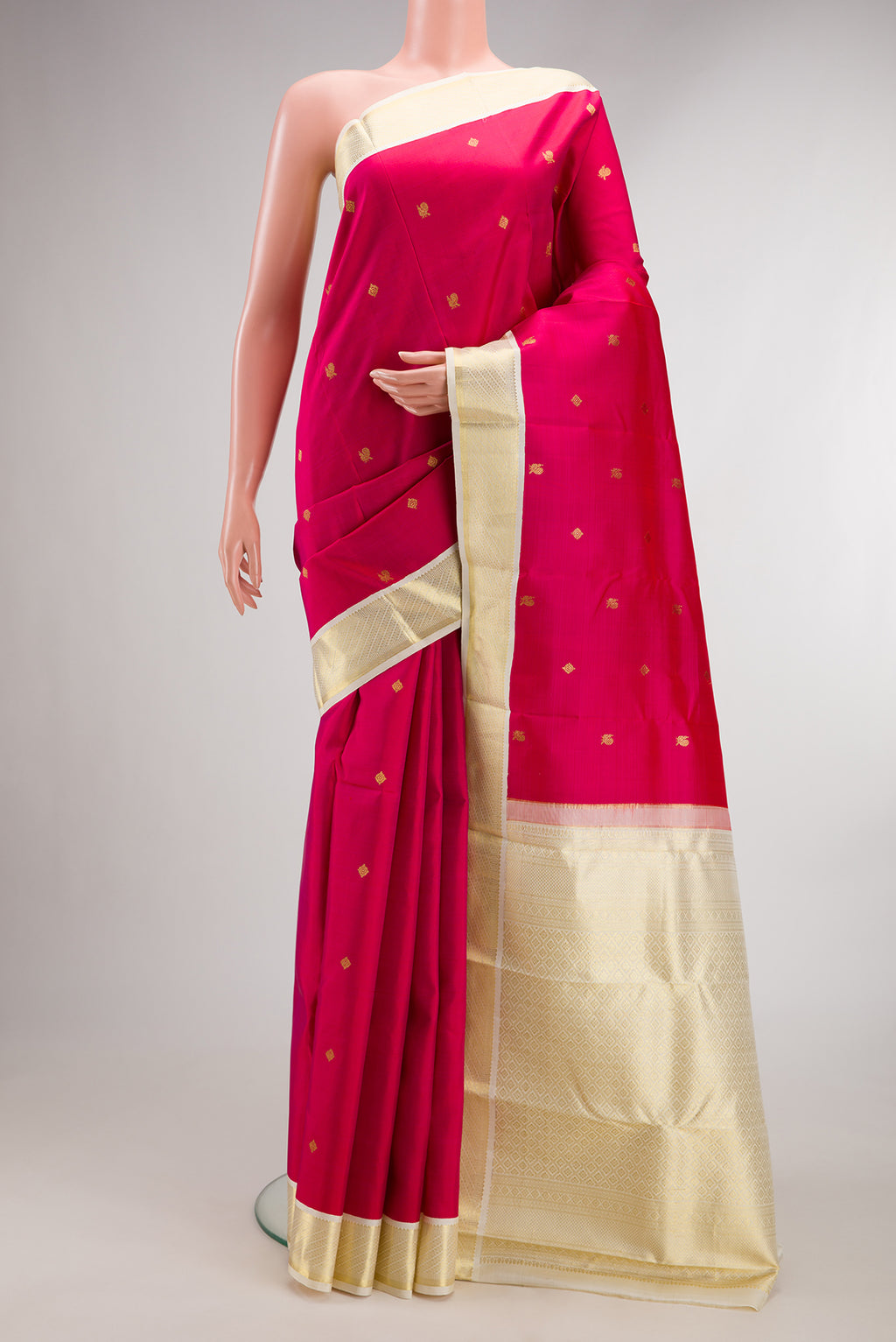 Pure Silk Dark Pink Kanjivaram Saree with Zari Butta on the body and Zari Border.  displayed on a mannequin
