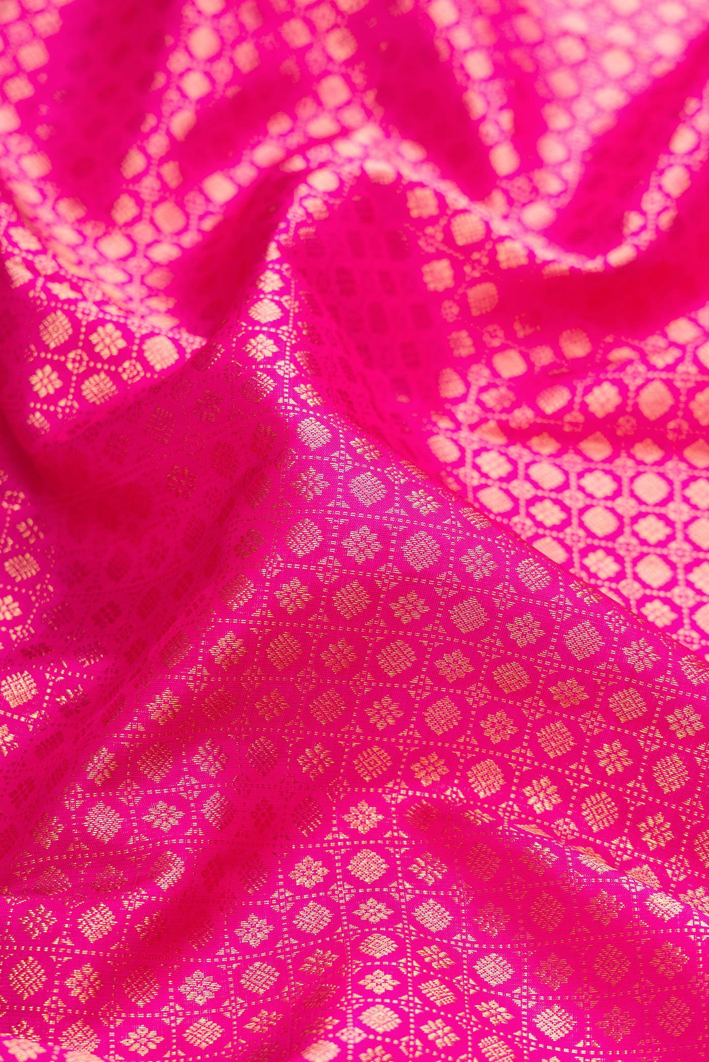 Close up of Pink Dual Tone Kanjivaram Silk Saree with Zari Brocade on the body and Zari Border.  displaying folds