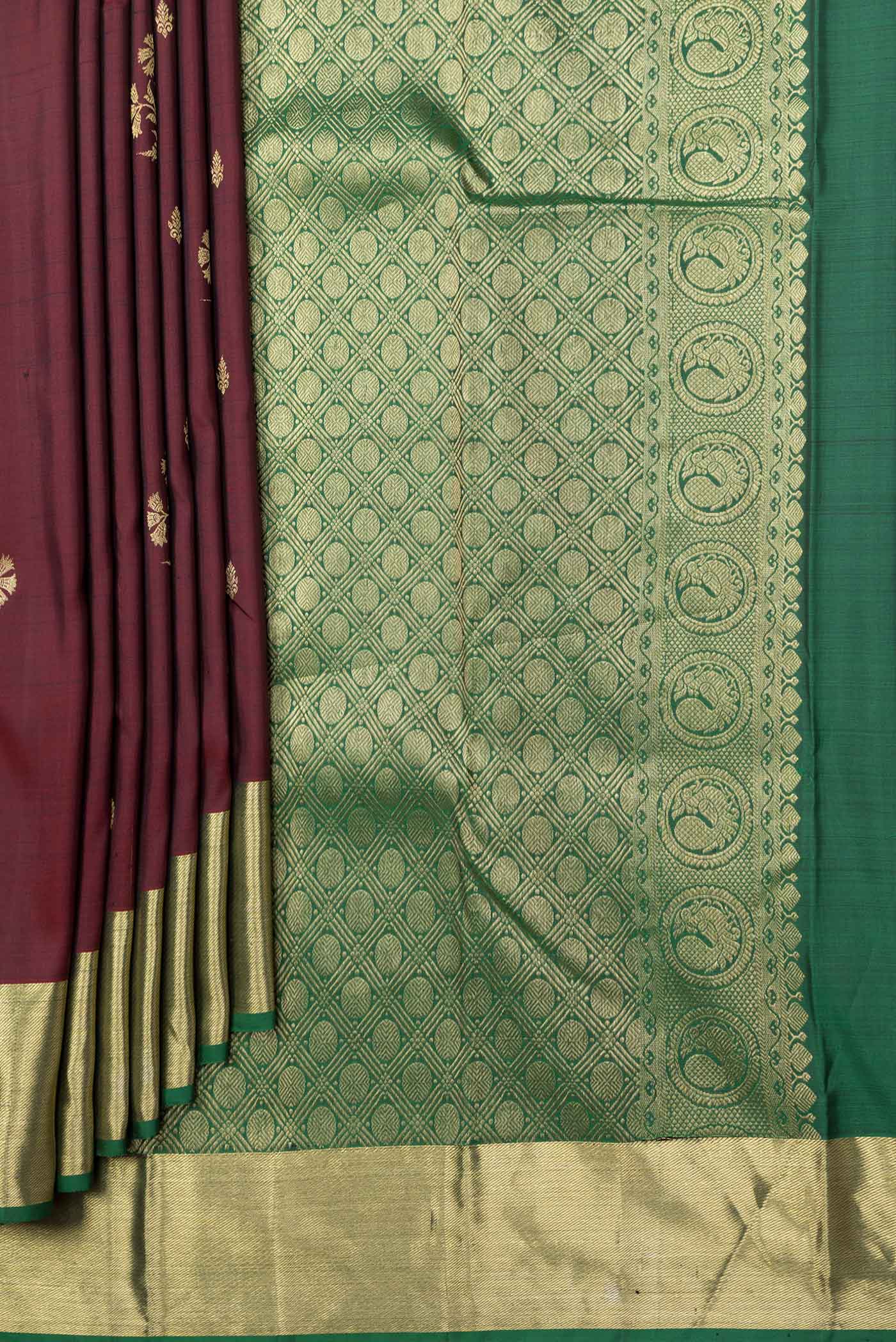 Pleats and pallu of Maroon Dual Tone Kanchipuram Silk Saree with Zari Butta on the body and Zari Border. 