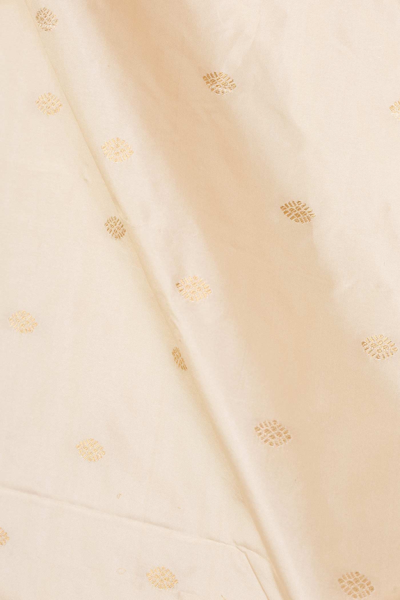 Close up of Cream Paithani Silk Saree with Zari Butta on the body and Paithani Border displaying folds