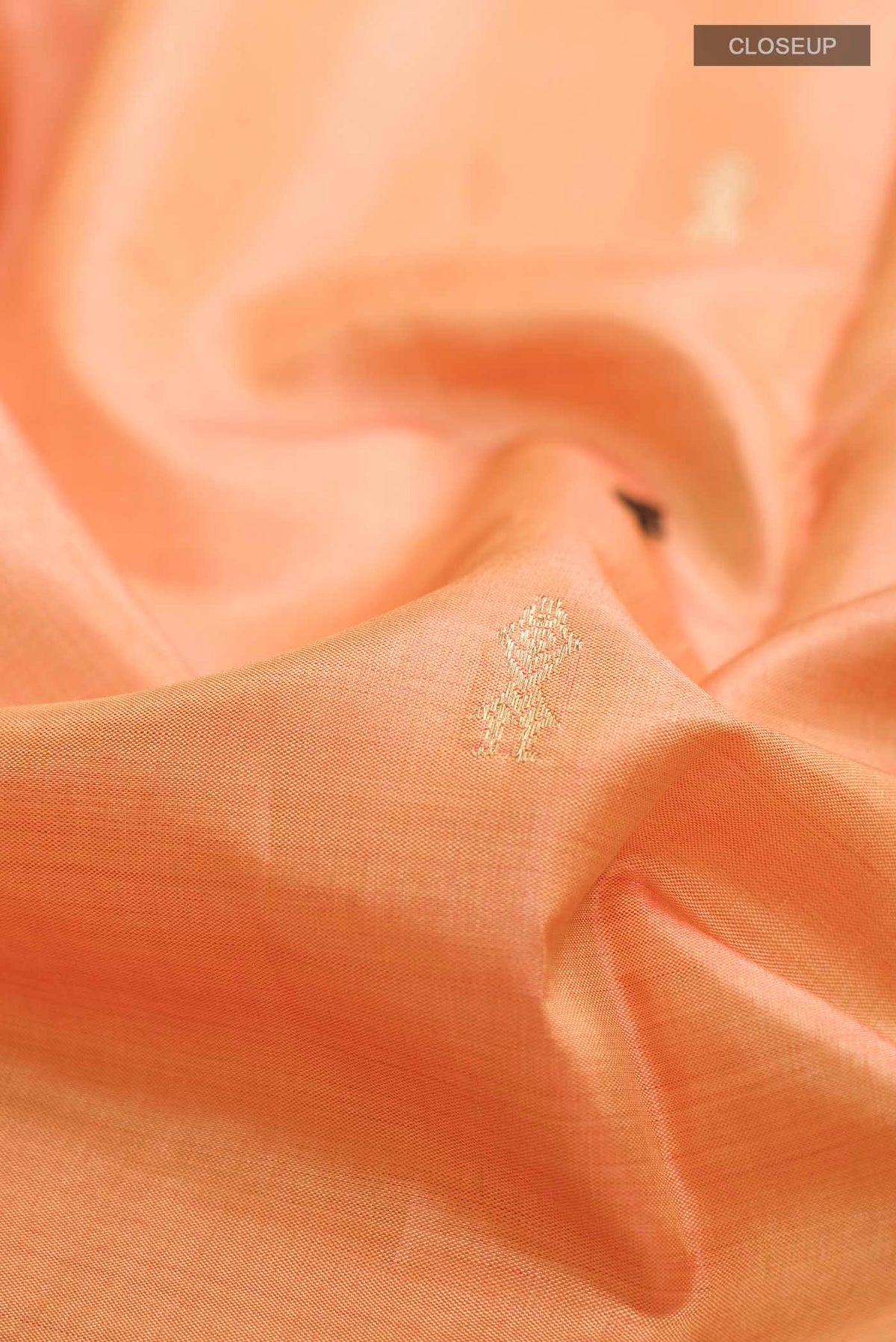 Close up of Orange Bhagalpuri Tussar Silk Saree with Zari Butta on the body and Zari Border displaying folds