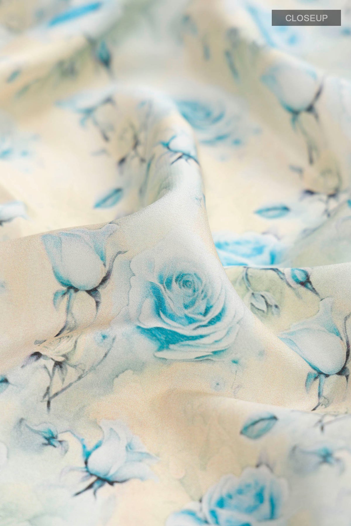 Close up of Cream Mysore Crepe Saree with Printed design on the body and Zari Border displaying folds