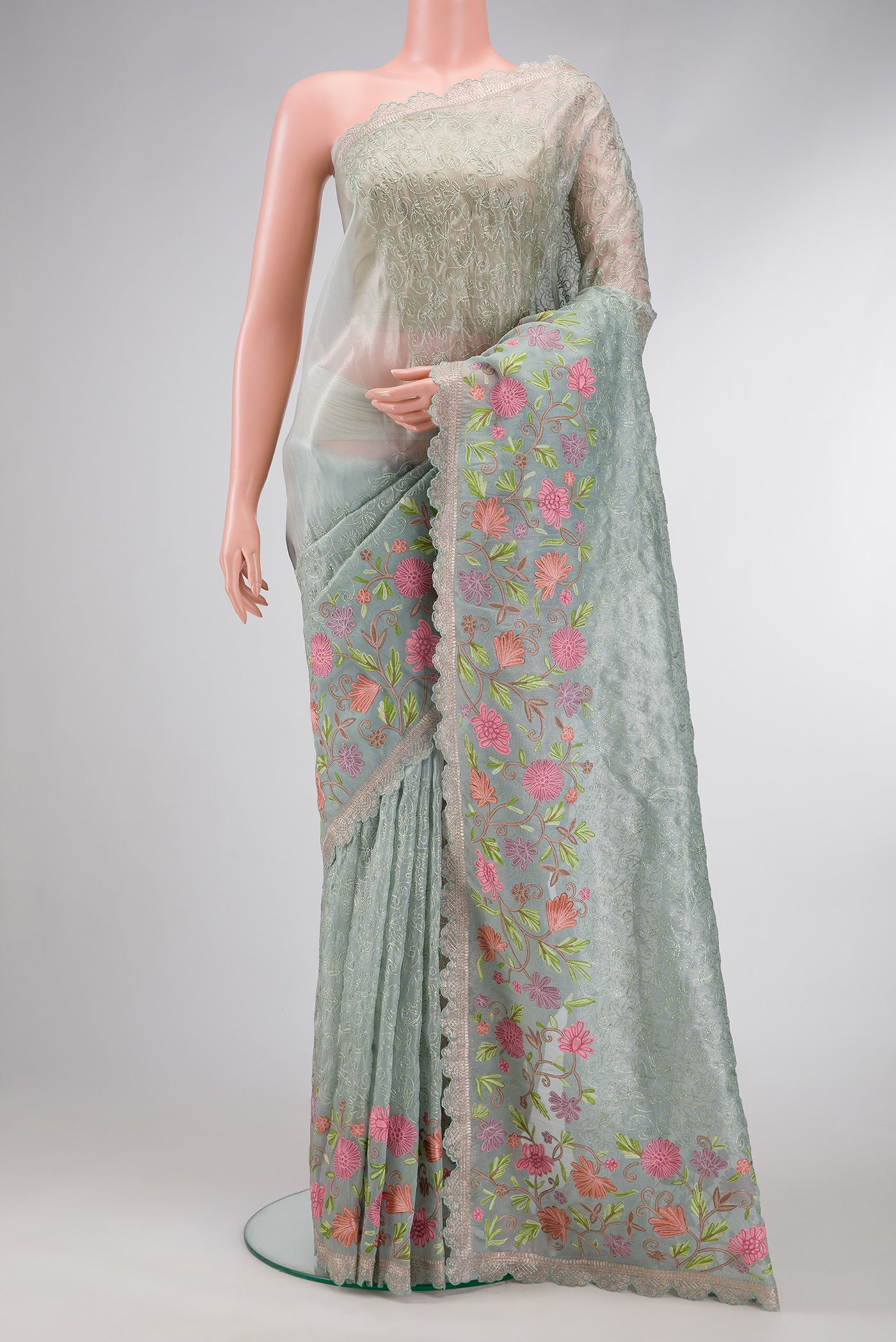 Light Green Dual Tone Organza Silk Saree with Embroidery on the body and Embroidery Border.  displayed on a mannequin