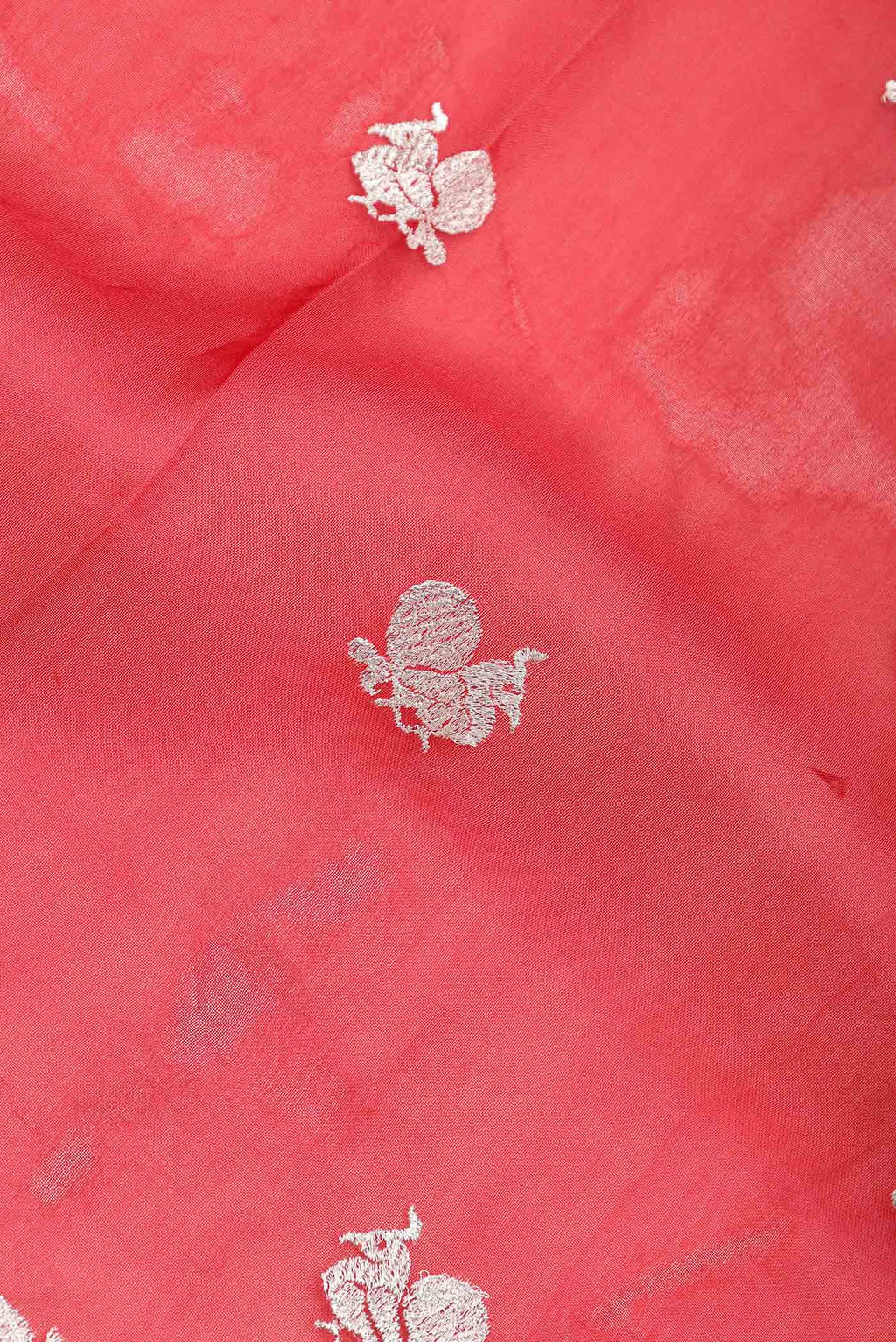 Close up of Red Dual Tone Organza Silk Saree with Zari Brocade on the body and Zari Border.  displaying folds
