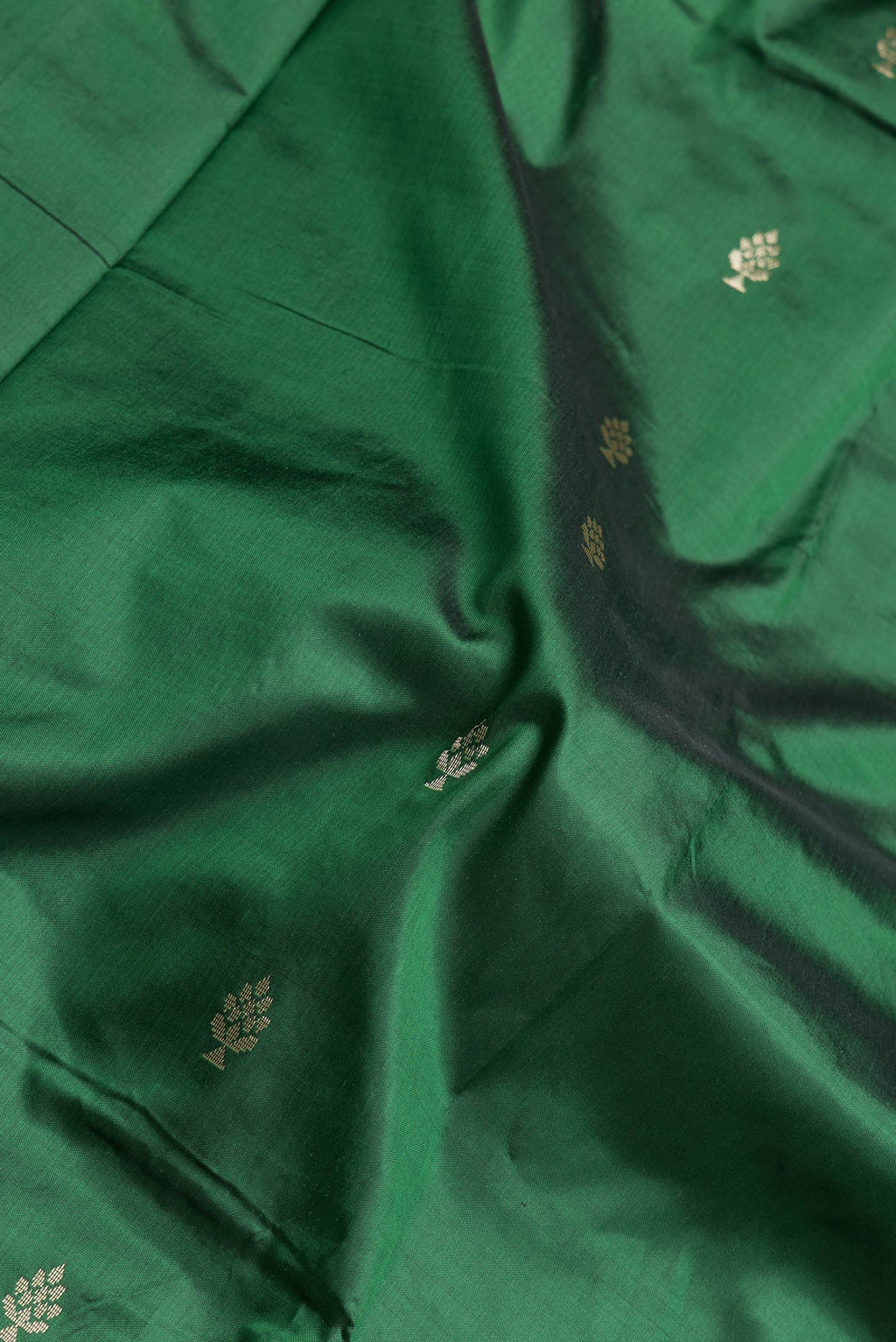 Close up of Bottle Green Dual Tone Banarasi Silk Saree with Zari Butta on the body and Zari Border.  displaying folds