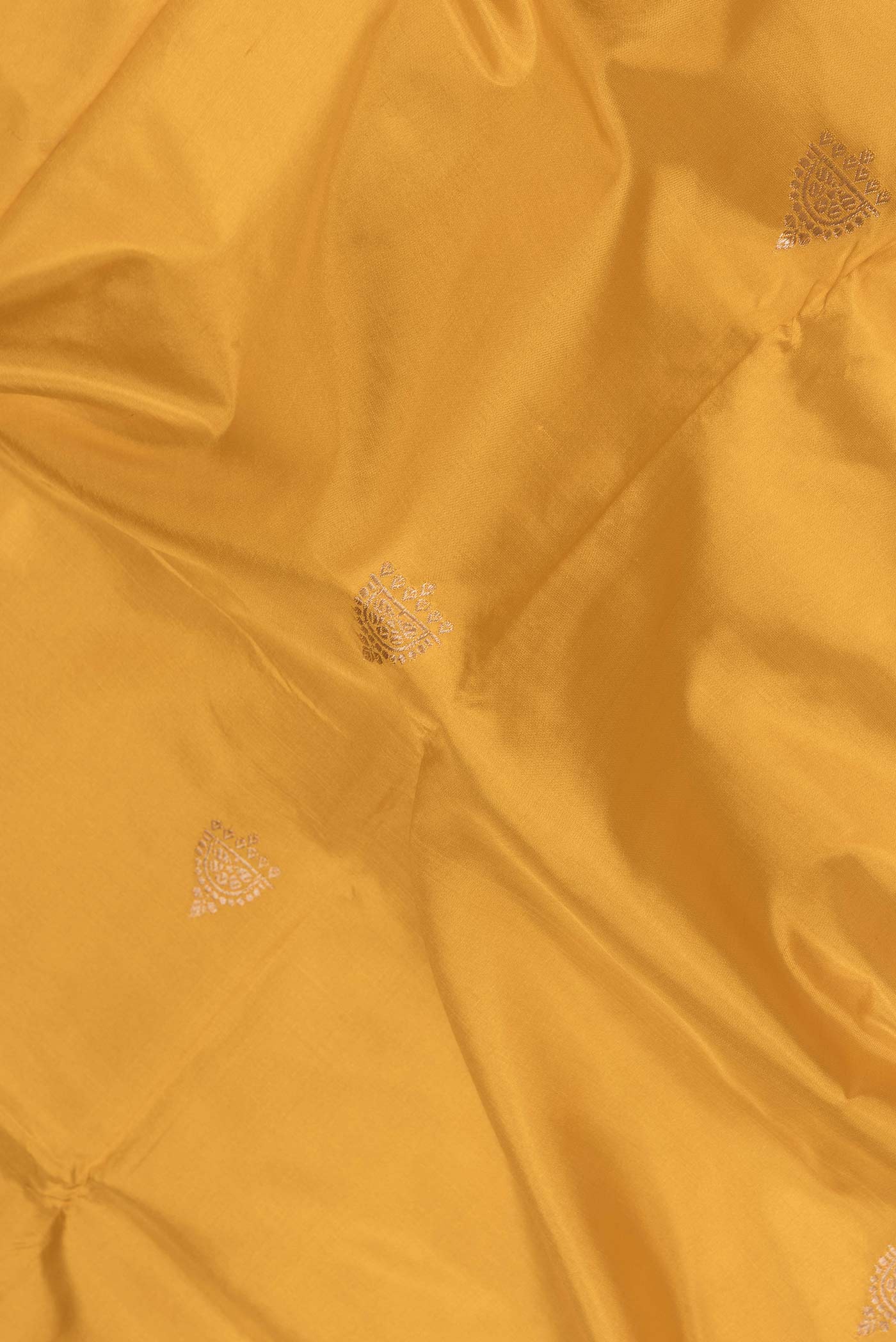 Close up of Yellow Dual Tone Banarasi Silk Saree with Zari Butta on the body and Zari Border.  displaying folds