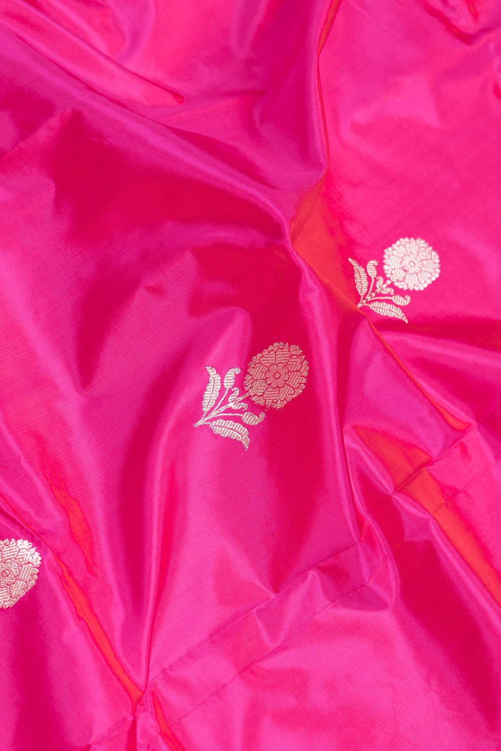 Close up of Pink Dual Tone Banarasi Silk Saree with Zari Butta on the body and Thread Border.  displaying folds