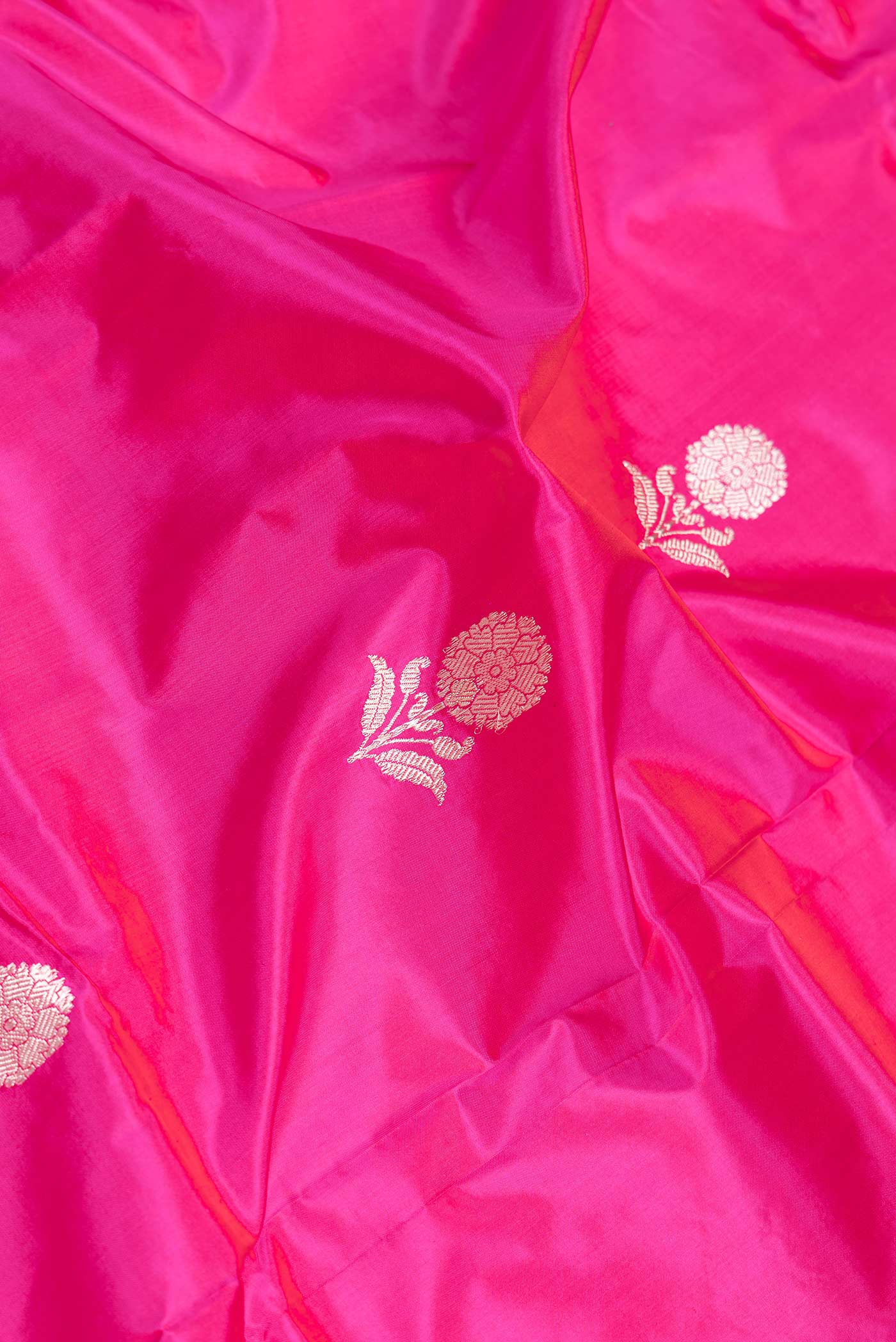 Close up of Pink Dual Tone Banarasi Silk Saree with Zari Butta on the body and Thread Border.  displaying folds