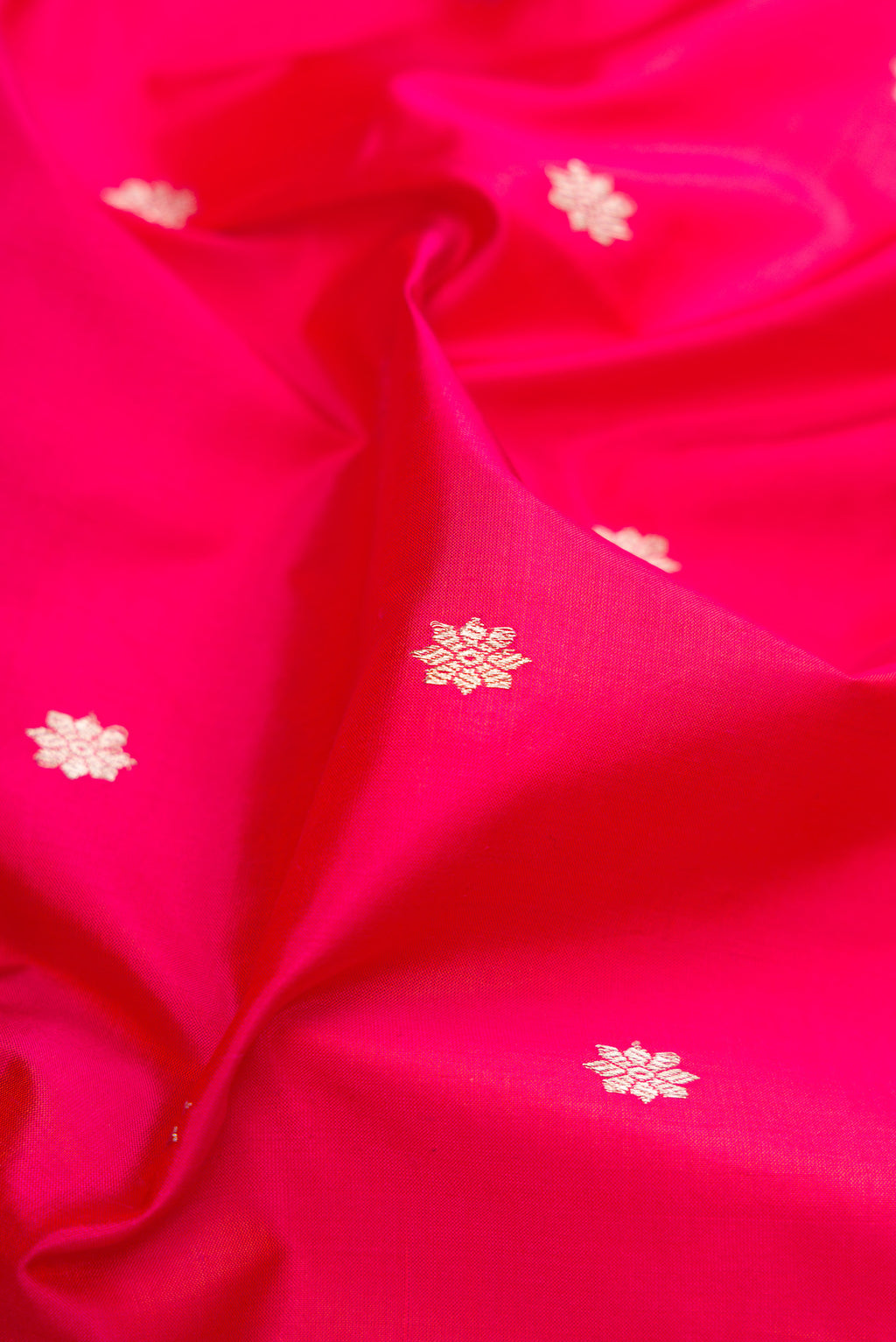 Close up of Pink Banarasi Silk Saree with Zari Butta on the body and Zari Border.  displaying folds
