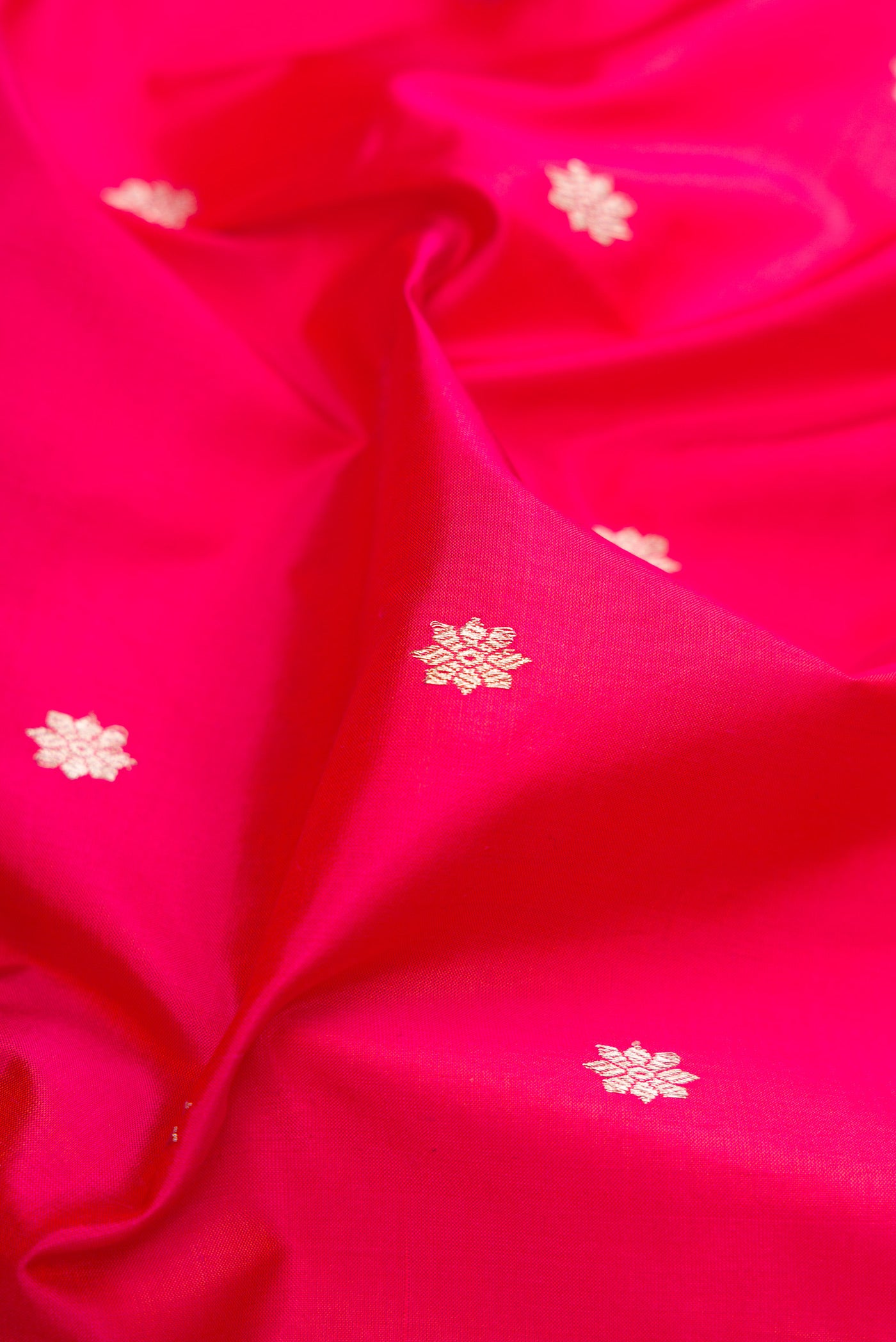 Close up of Pink Banarasi Silk Saree with Zari Butta on the body and Zari Border.  displaying folds