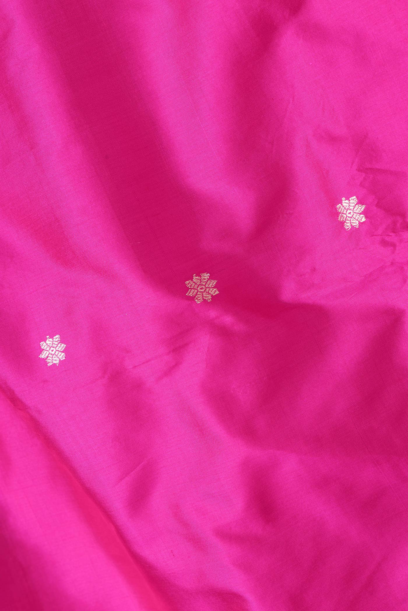 Close up of Dark Pink Dual Tone Banarasi Silk Saree with Zari Butta on the body and Zari Border.  displaying folds