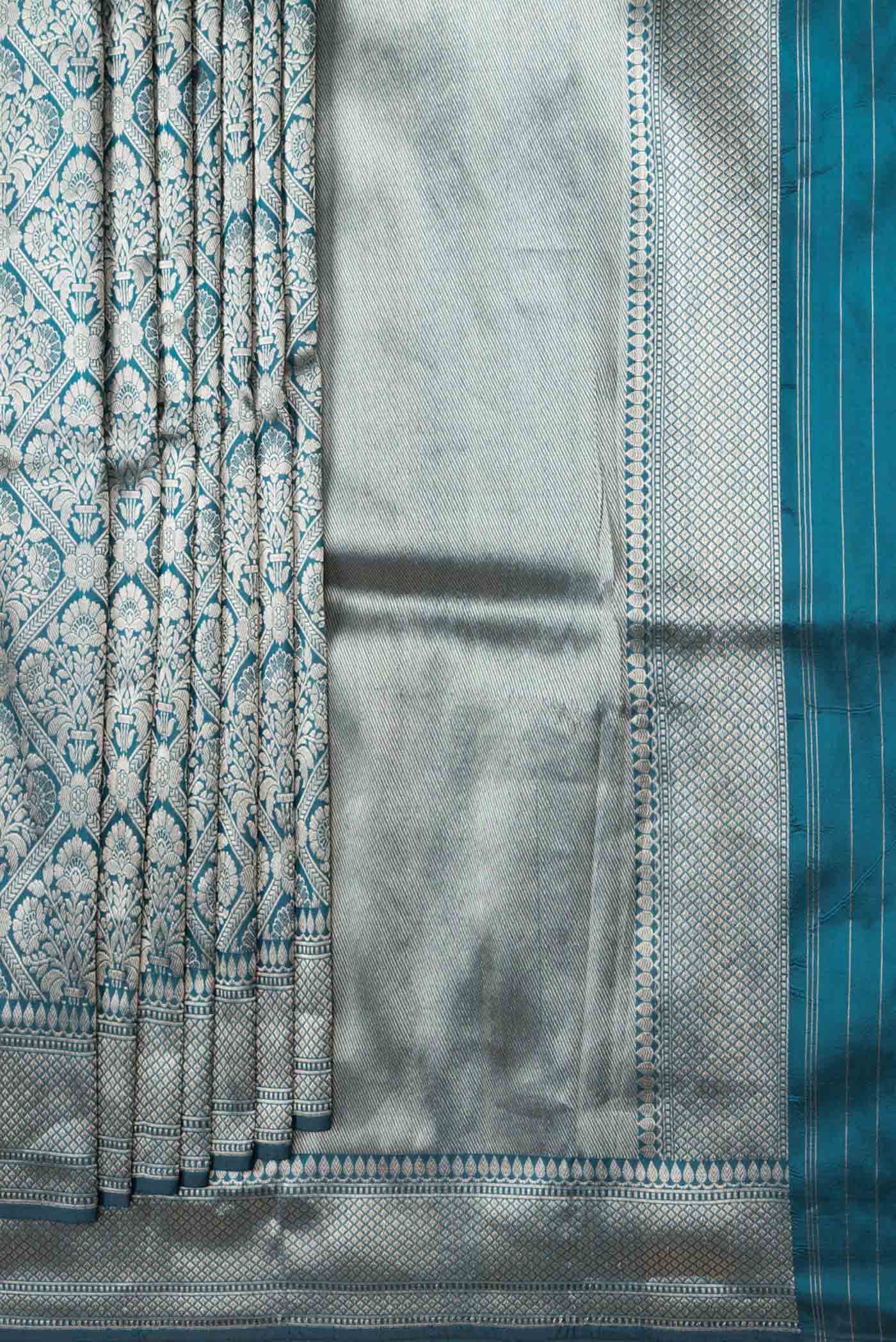 Pleats and pallu of Peacock Blue Dual Tone Banarasi Silk Saree with Zari Brocade on the body and Zari Border. 