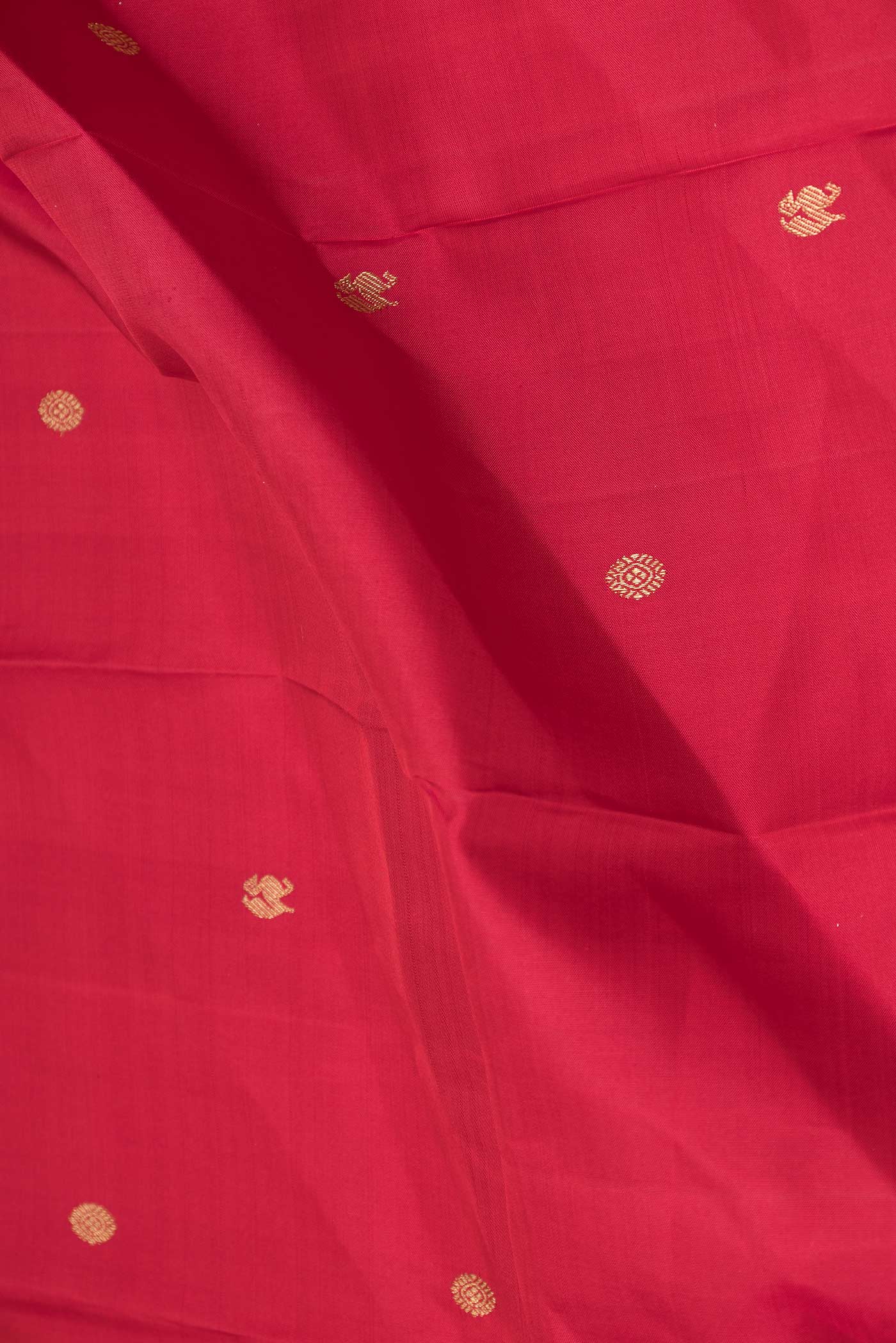 Close up of Pure Silk Pure Zari Maroon Dual Tone Kanchipuram Saree with Zari Butta on the body and Zari Border displaying folds