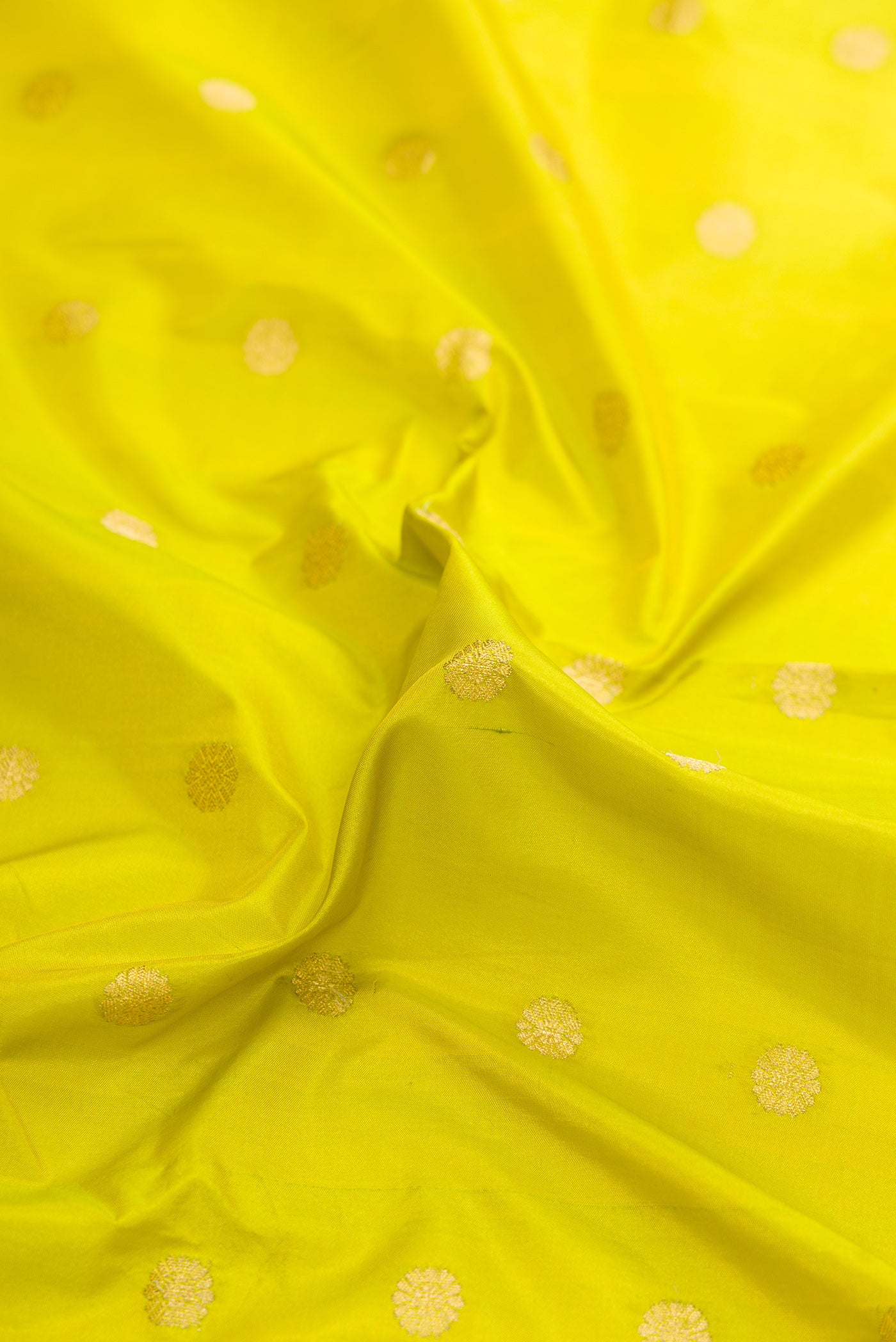 Close up of Parrot Green Dual Tone Paithani Silk Saree with Zari Butta on the body and Zari Border.  displaying folds