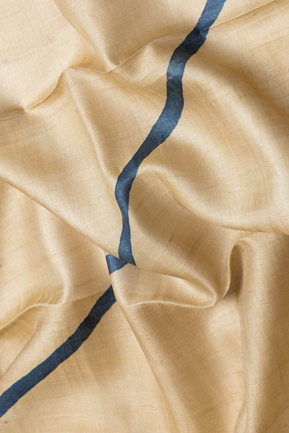 Close up of Maroon Dual Tone Tussar Silk Saree with Printed design on the body and Without Border.  displaying folds