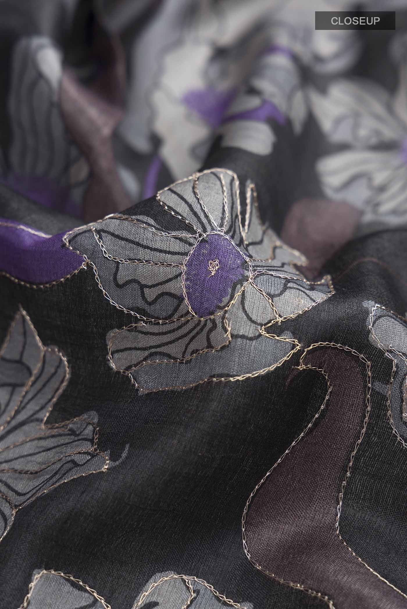 Close up of Black Bhagalpuri Tussar Silk Saree with Printed design on the body and Zari Border displaying folds