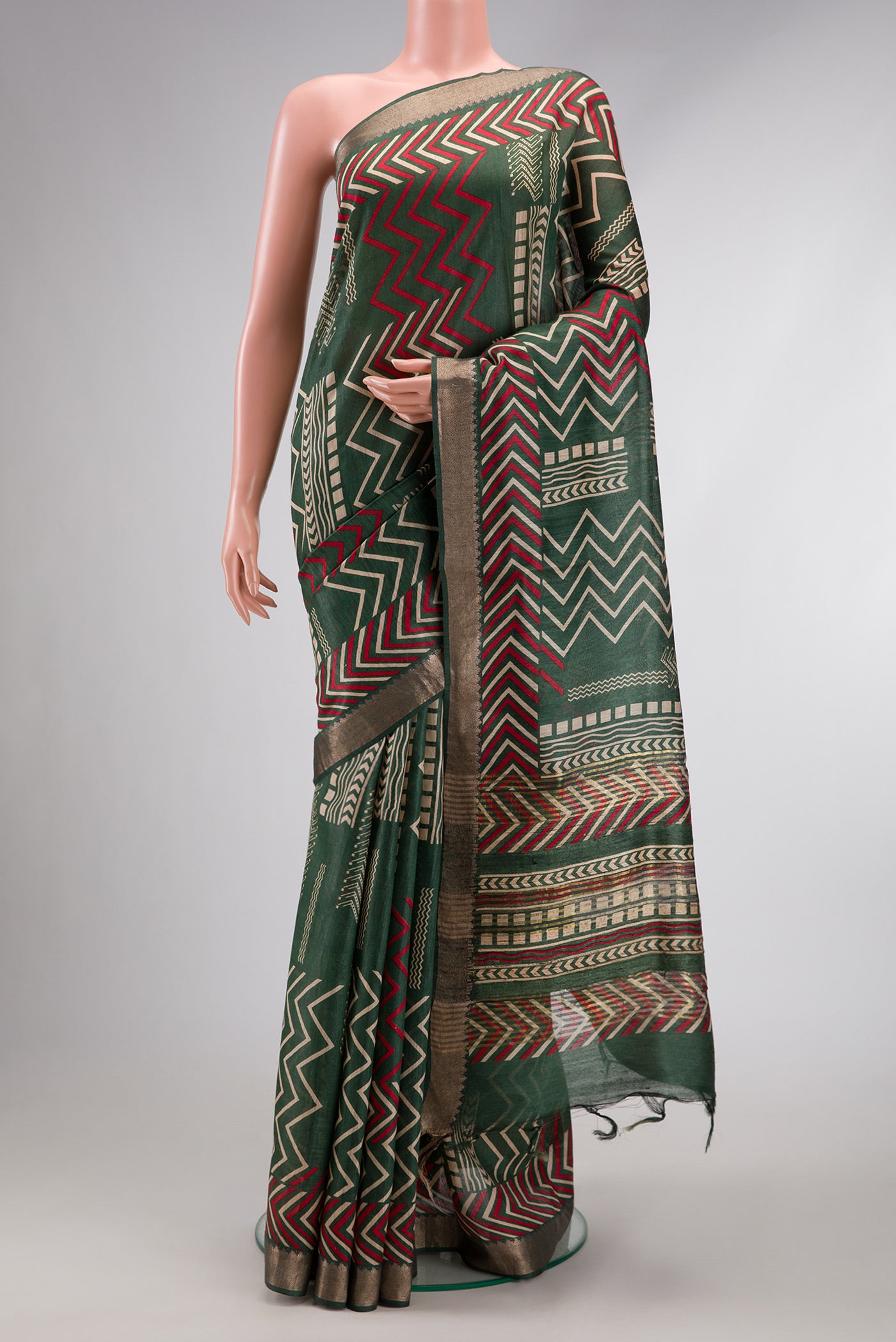 Green Dual Tone Tussar Silk Saree with Printed design on the body and Zari Border.  displayed on a mannequin