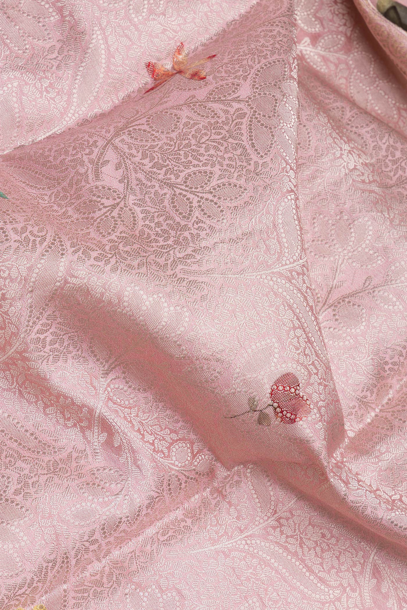 Close up of Pink Tussar Silk Saree with Zari Brocade on the body and Fancy Border.  displaying folds