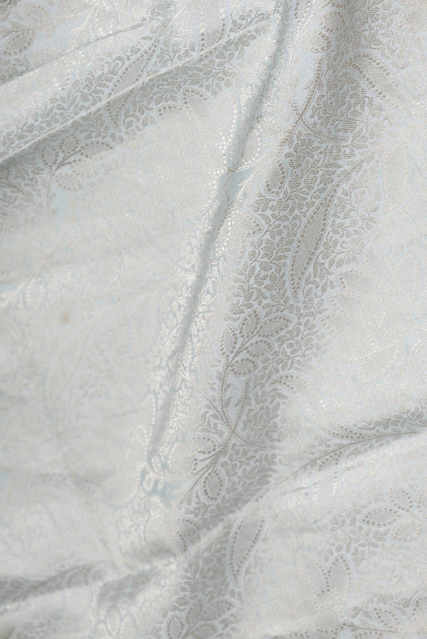Close up of Grey Dual Tone Tussar Saree with Zari Brocade on the body and Fancy Border displaying folds