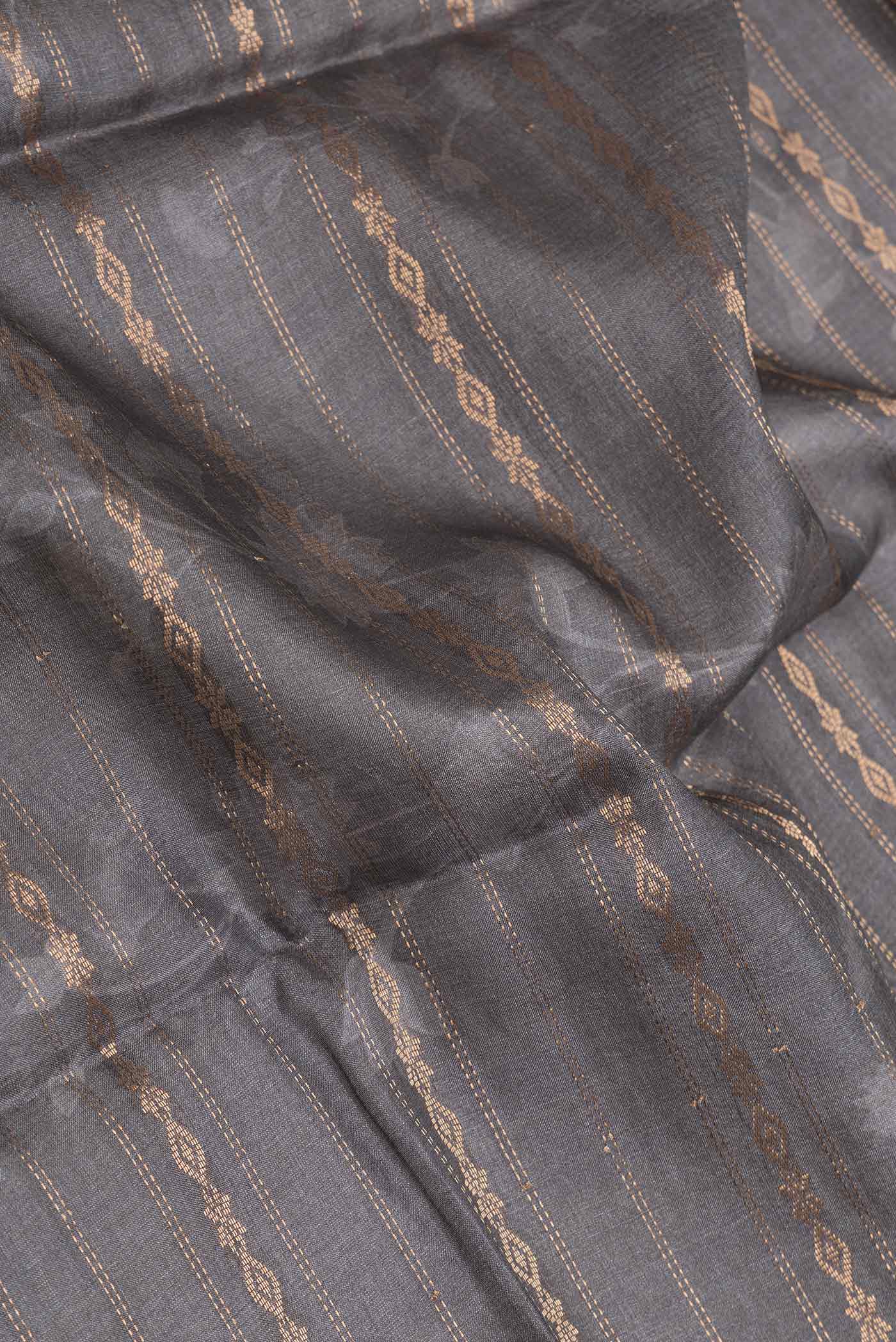 Close up of Grey Dual Tone Tussar Silk SareePrinted design on the body and Zari Border displaying folds