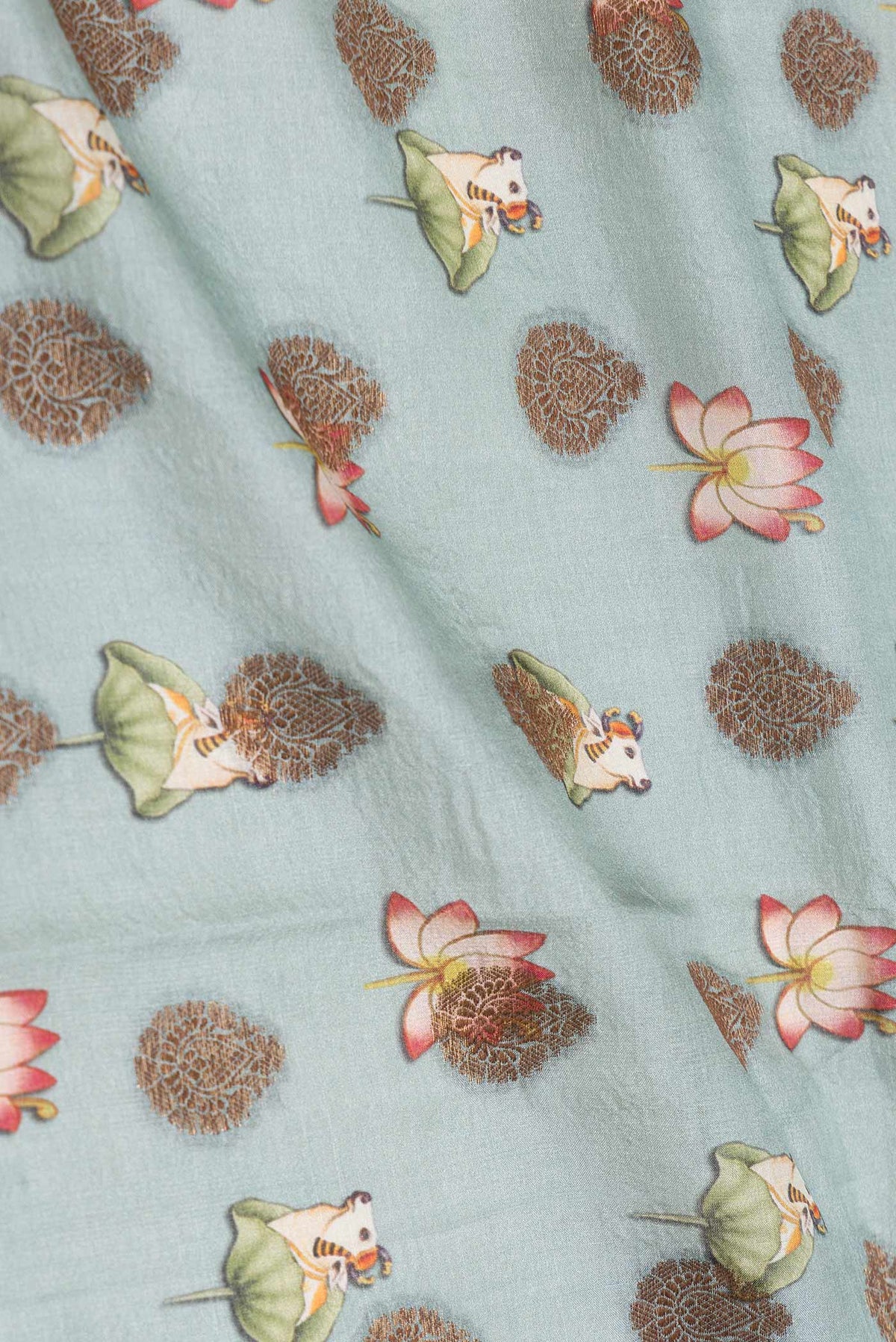 Close up of Grey Dual Tone Tussar Saree with Zari Butta on the body and Zari Border displaying folds