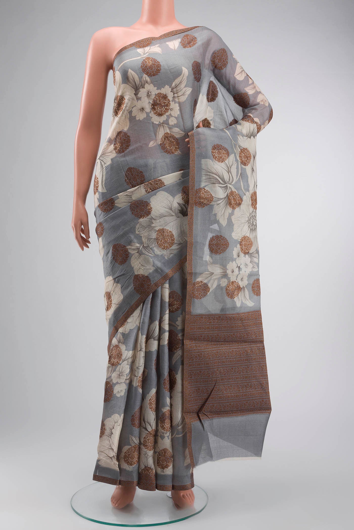 Grey Tussar Silk Saree with Zari Butta on the body and Zari Border displayed on a mannequin