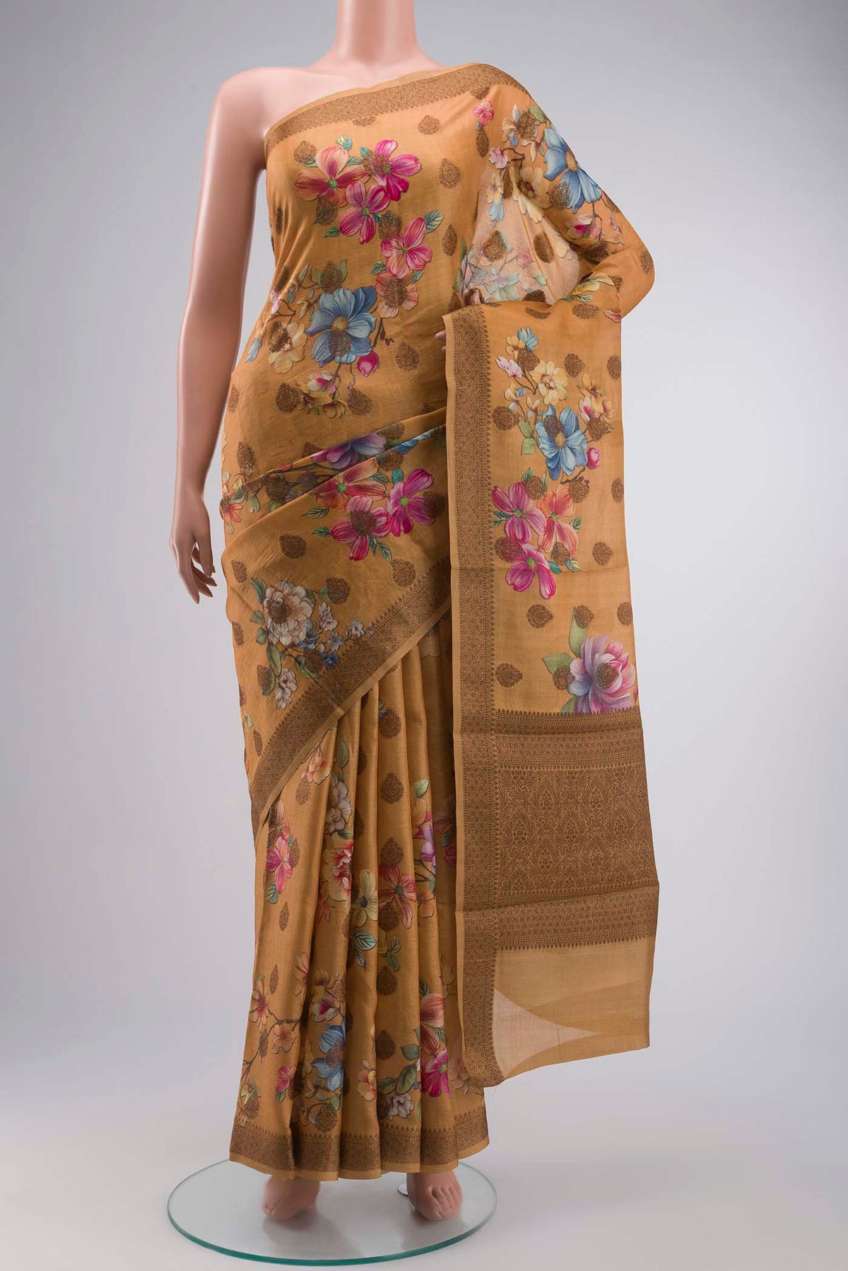 Mustard Tussar Silk Saree with Printed design on the body and Zari Border displayed on a mannequin