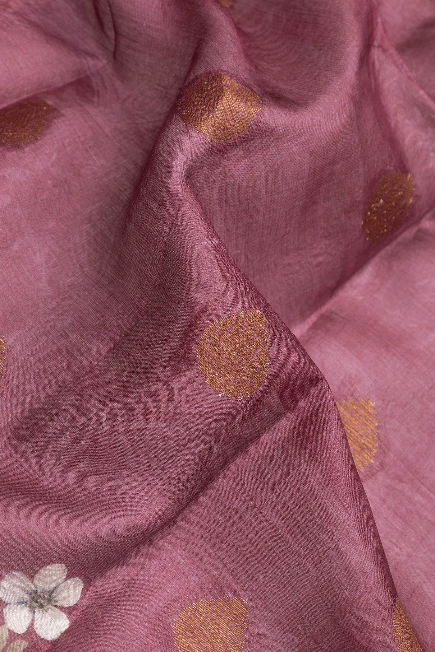 Close up of Mauve Dual Tone Tussar Silk Saree with Printed design on the body and Thread Border.  displaying folds
