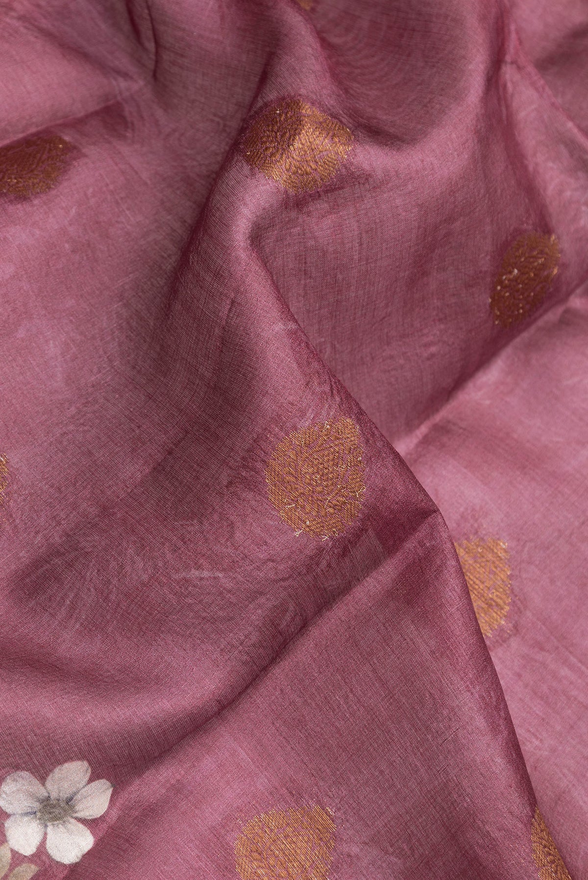 Close up of Mauve Dual Tone Tussar Silk Saree with Printed design on the body and Thread Border.  displaying folds