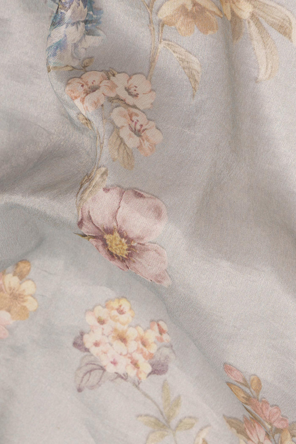 Close up of Grey Organza Saree with Floral Print on the body and Zari Border.  displaying folds