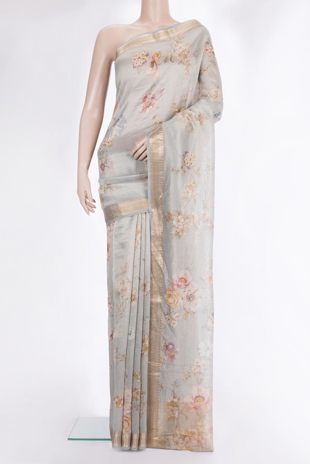 Grey Organza Saree with Floral Print on the body and Zari Border.  displayed on a mannequin