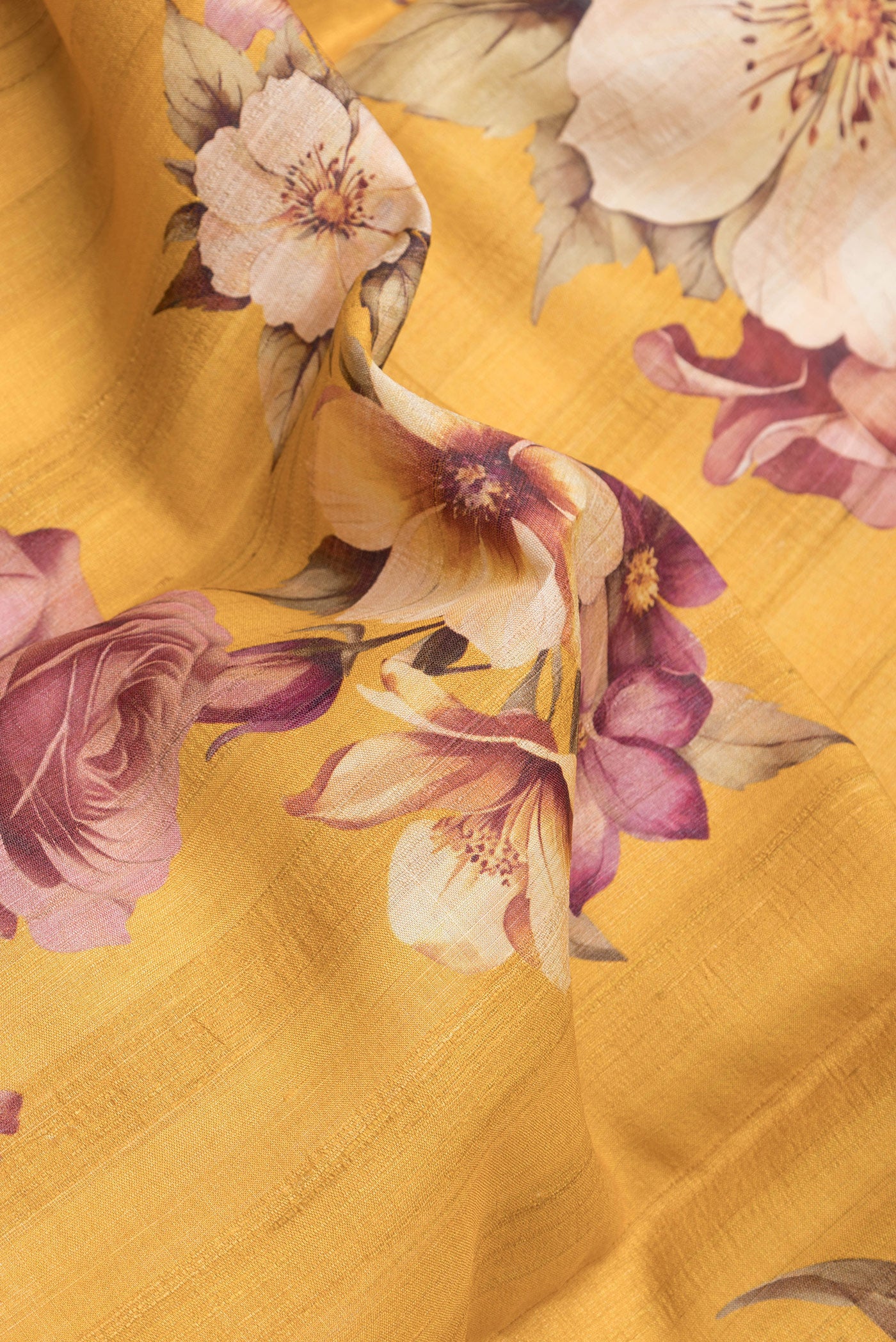 Close up of Yellow Dual Tone Tussar Silk Saree with Printed design on the body and Zari Border.  displaying folds