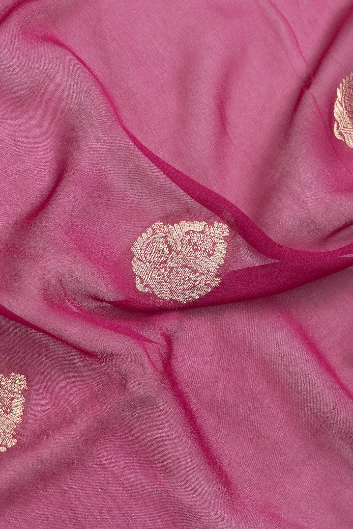 Close up of Magenta Dual Tone Mysore Georgette Saree with Zari Butta on the body and Zari Border.  displaying folds