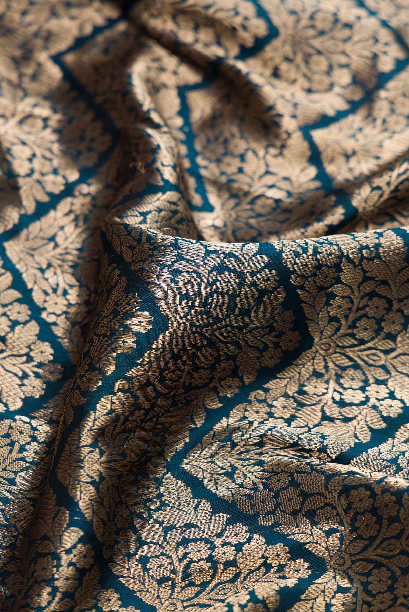 Close up of Maya Blue Dual Tone Banarasi Silk Saree with Zari Brocade on the body and Zari Border displaying folds