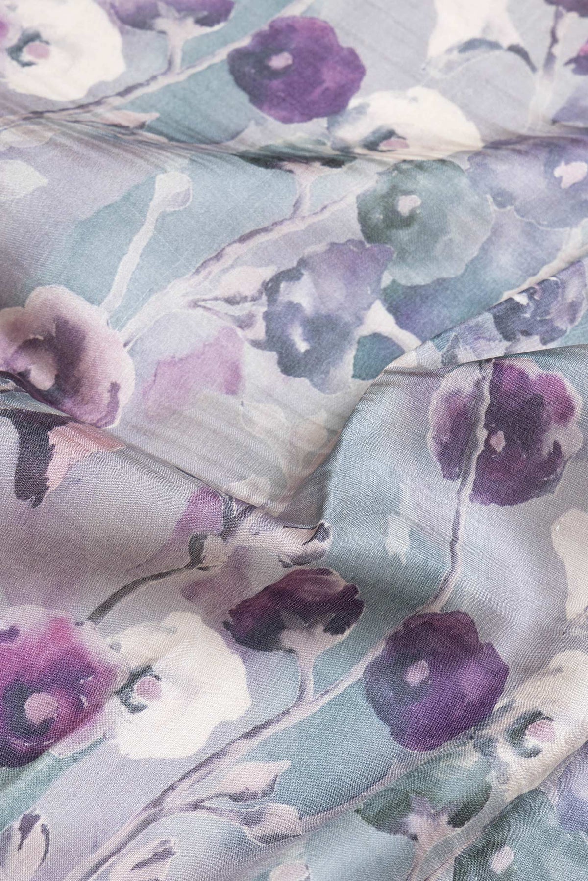Close up of Grey Dual Tone Tussar Silk Saree with Printed design on the body and Zari Border.  displaying folds
